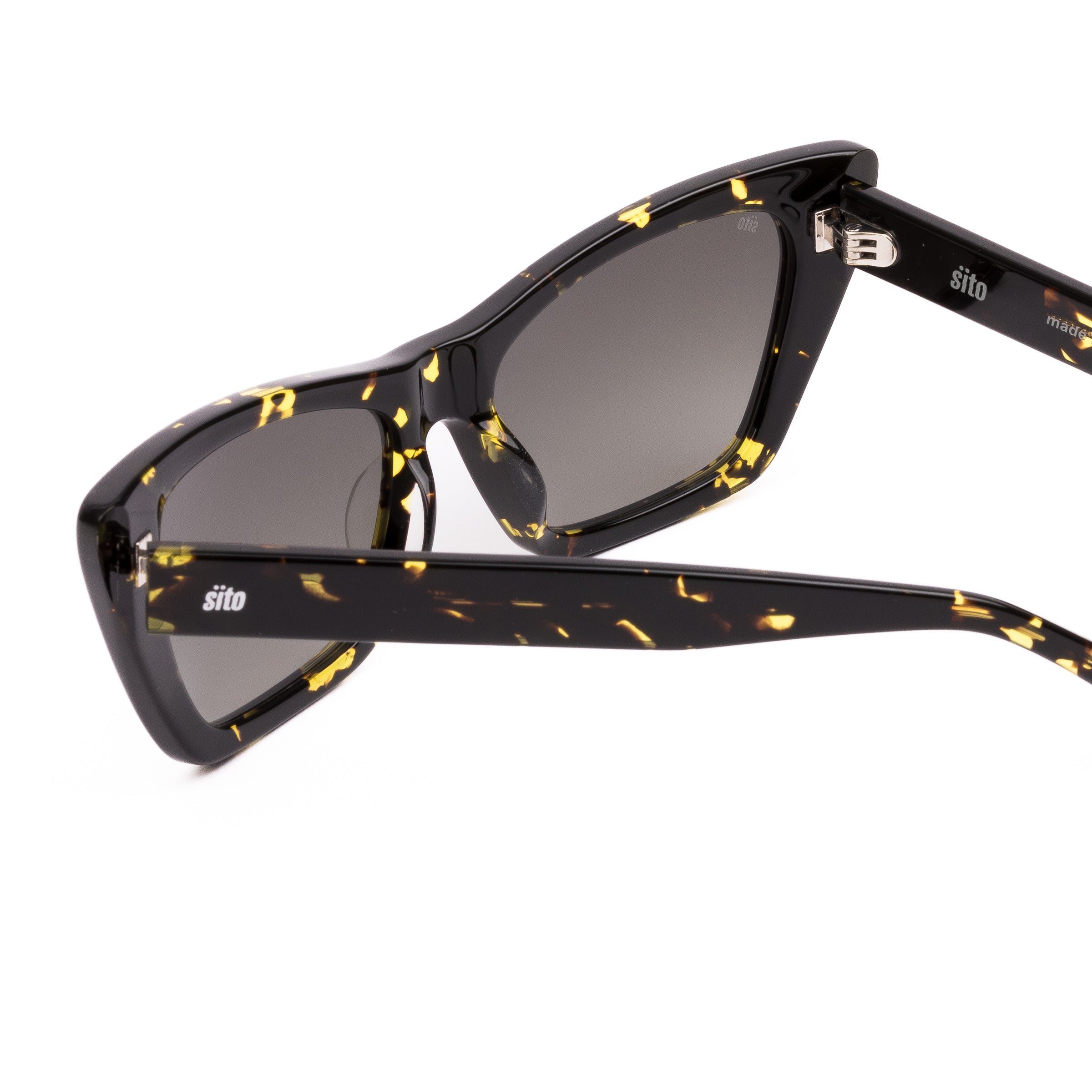 Cat-eye sunglasses with black frame and yellow accents on a white background