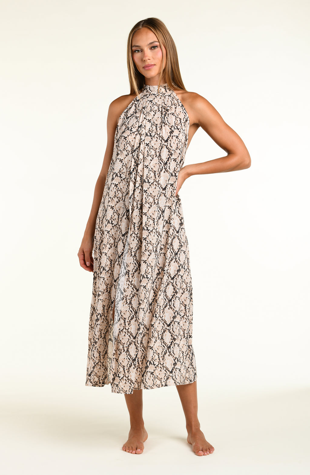 Woman wearing a snakeskin printed midi dress cover up against a white background. 