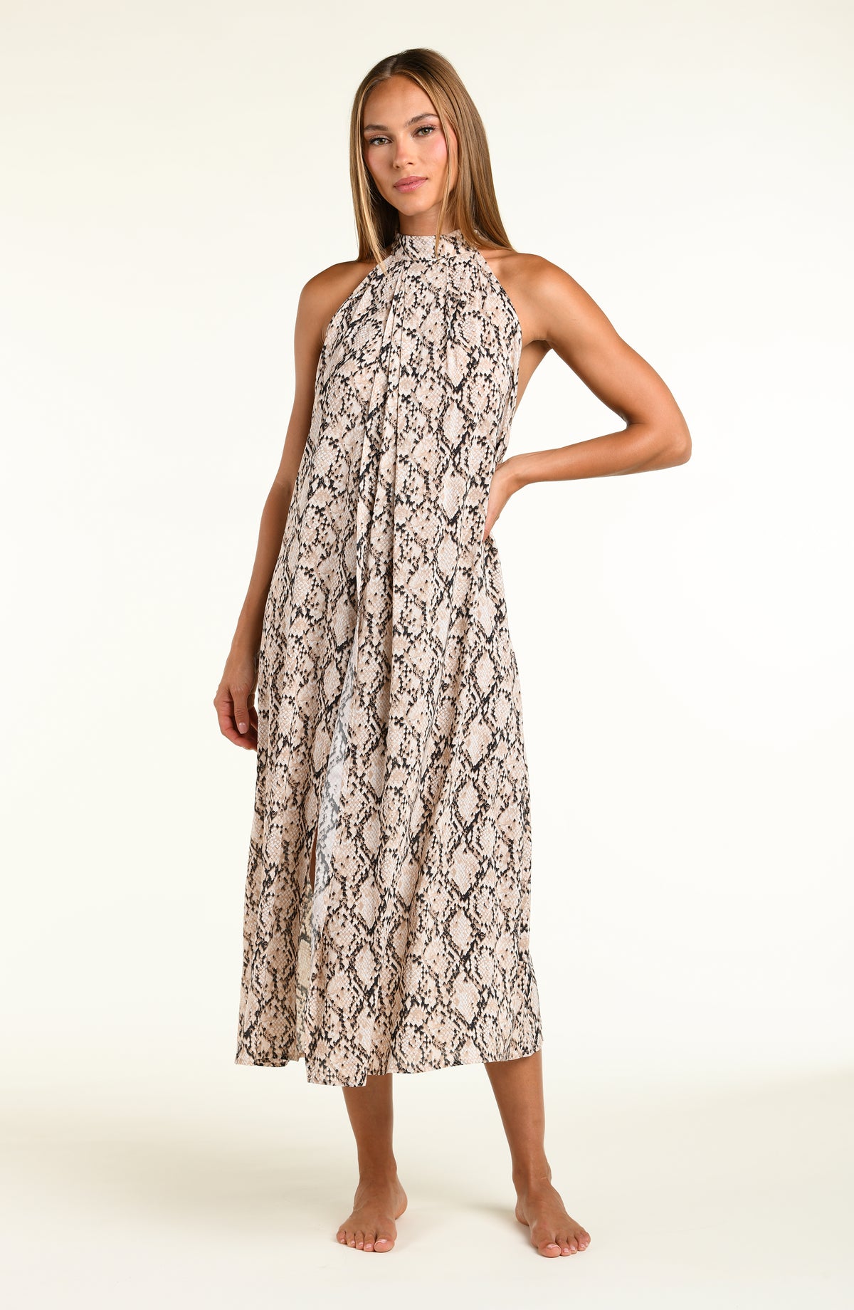 Woman wearing a snakeskin printed midi dress cover up against a white background. 