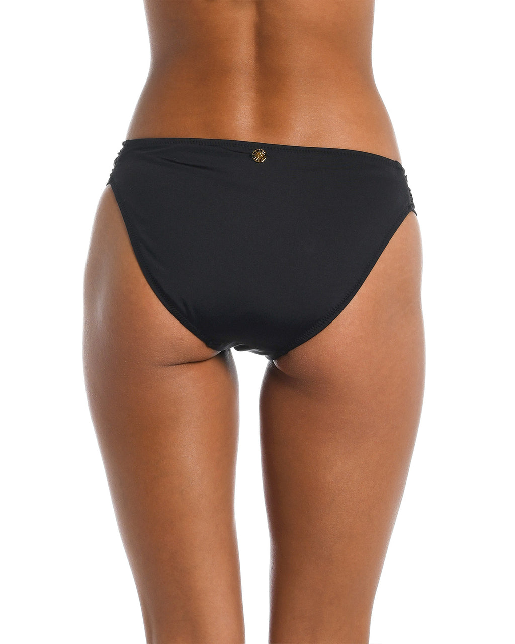 Black bikini bottom worn by a person on a white background