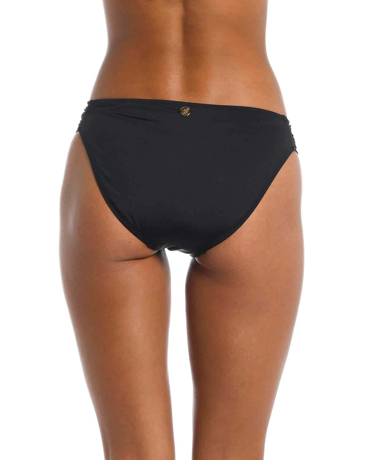 Black bikini bottom worn by a person on a white background