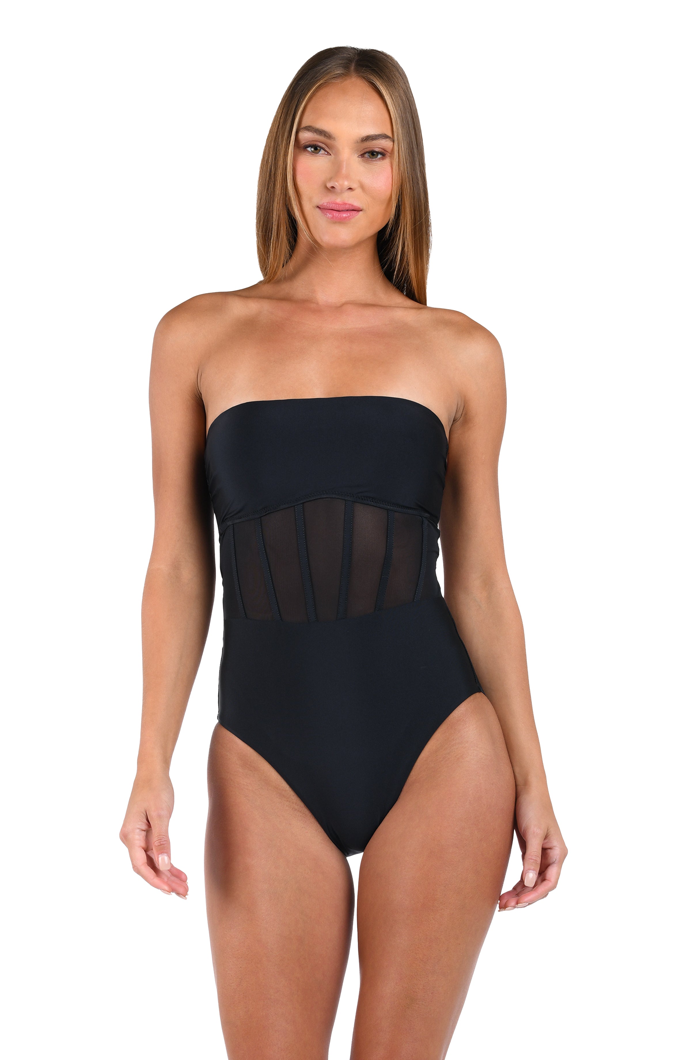 Woman wearing a black strapless swimsuit with mesh panels on a white background