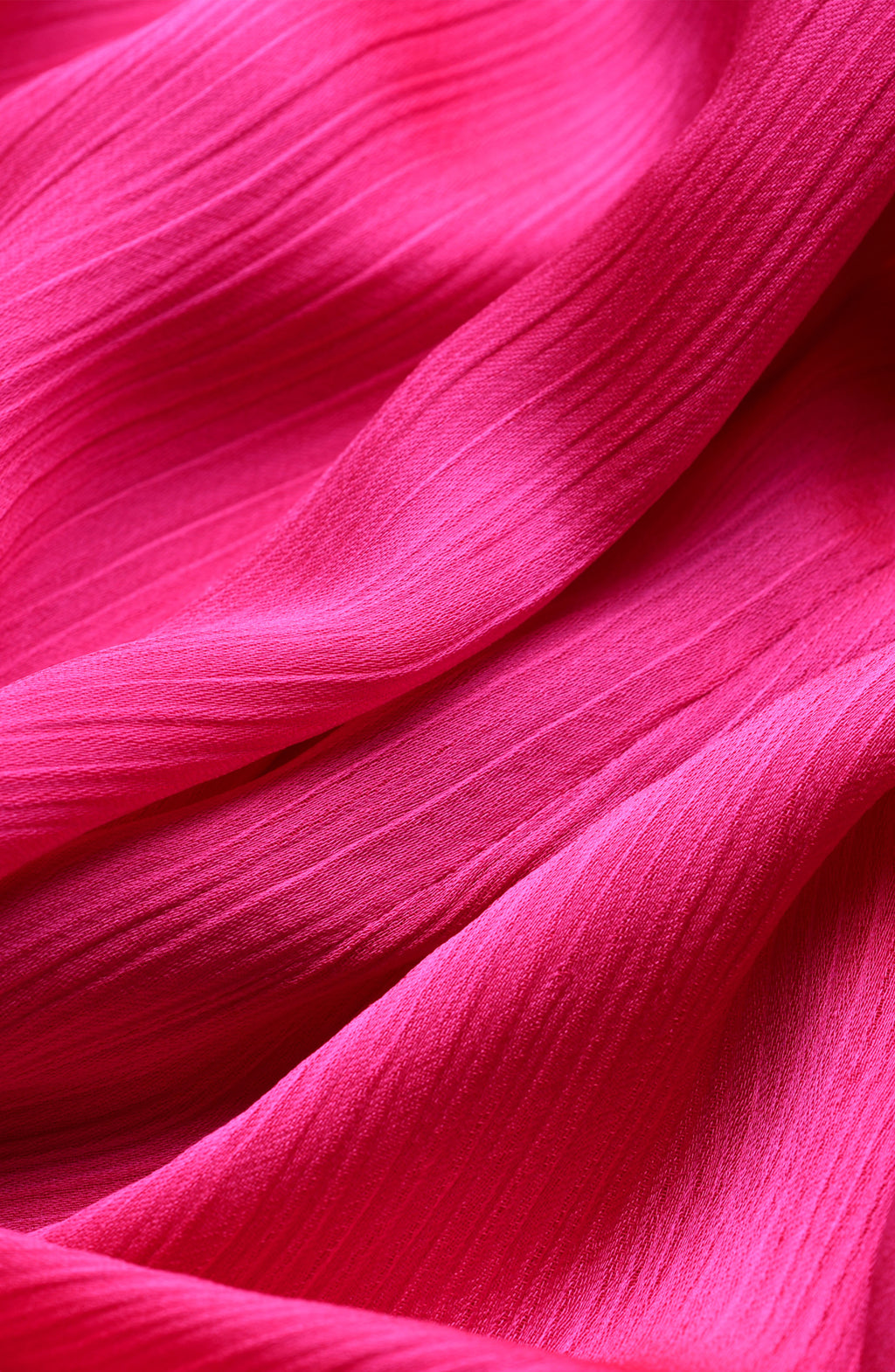 Close-up of bright pink fabric with a crinkled pattern