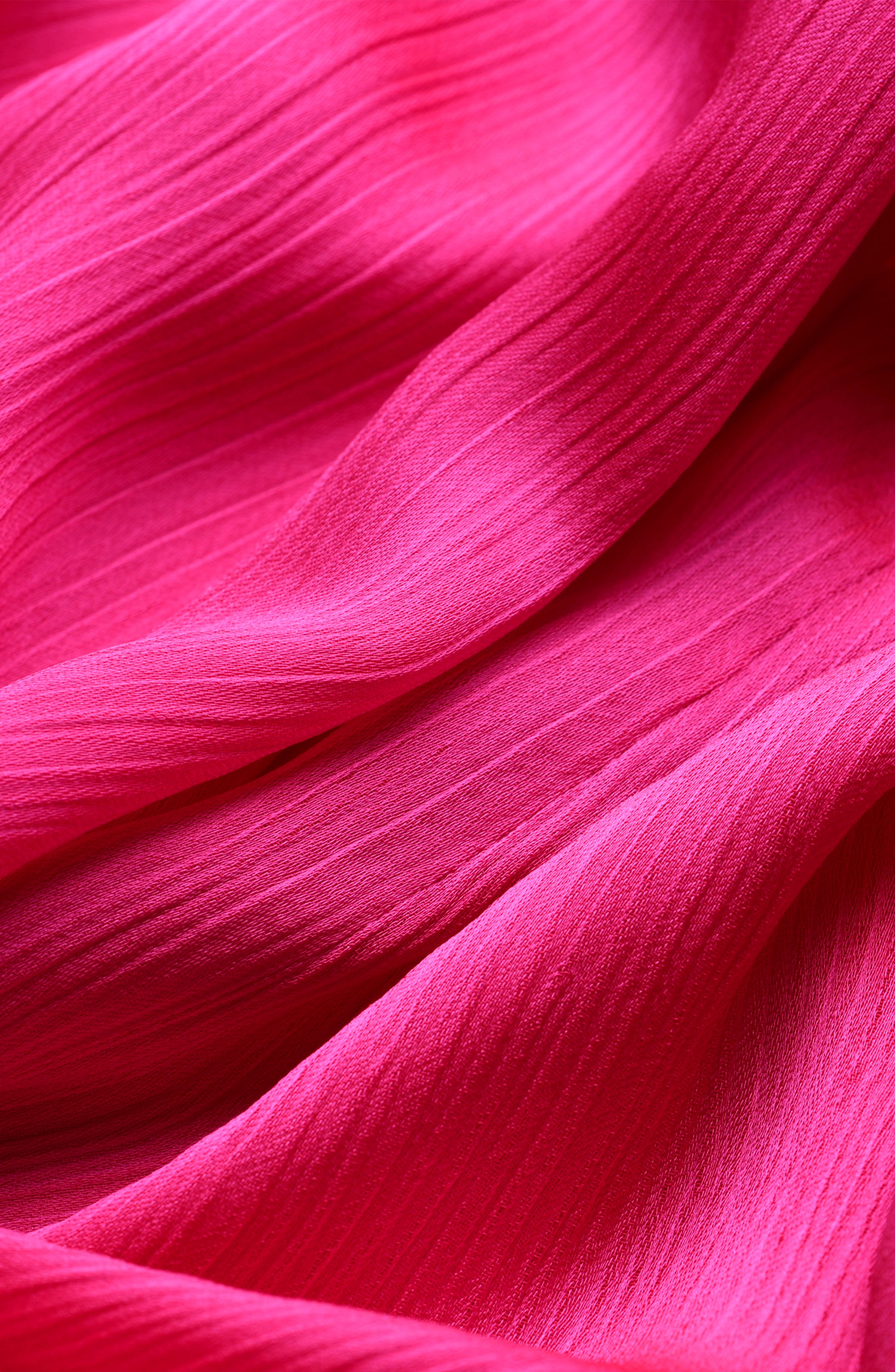 Close-up of bright pink fabric with a crinkled pattern