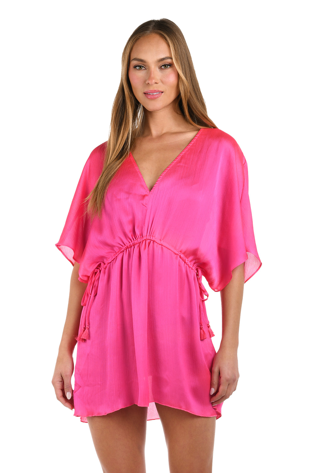 Front image of model wearing a solid bright pink V-neck tunic cover up.        