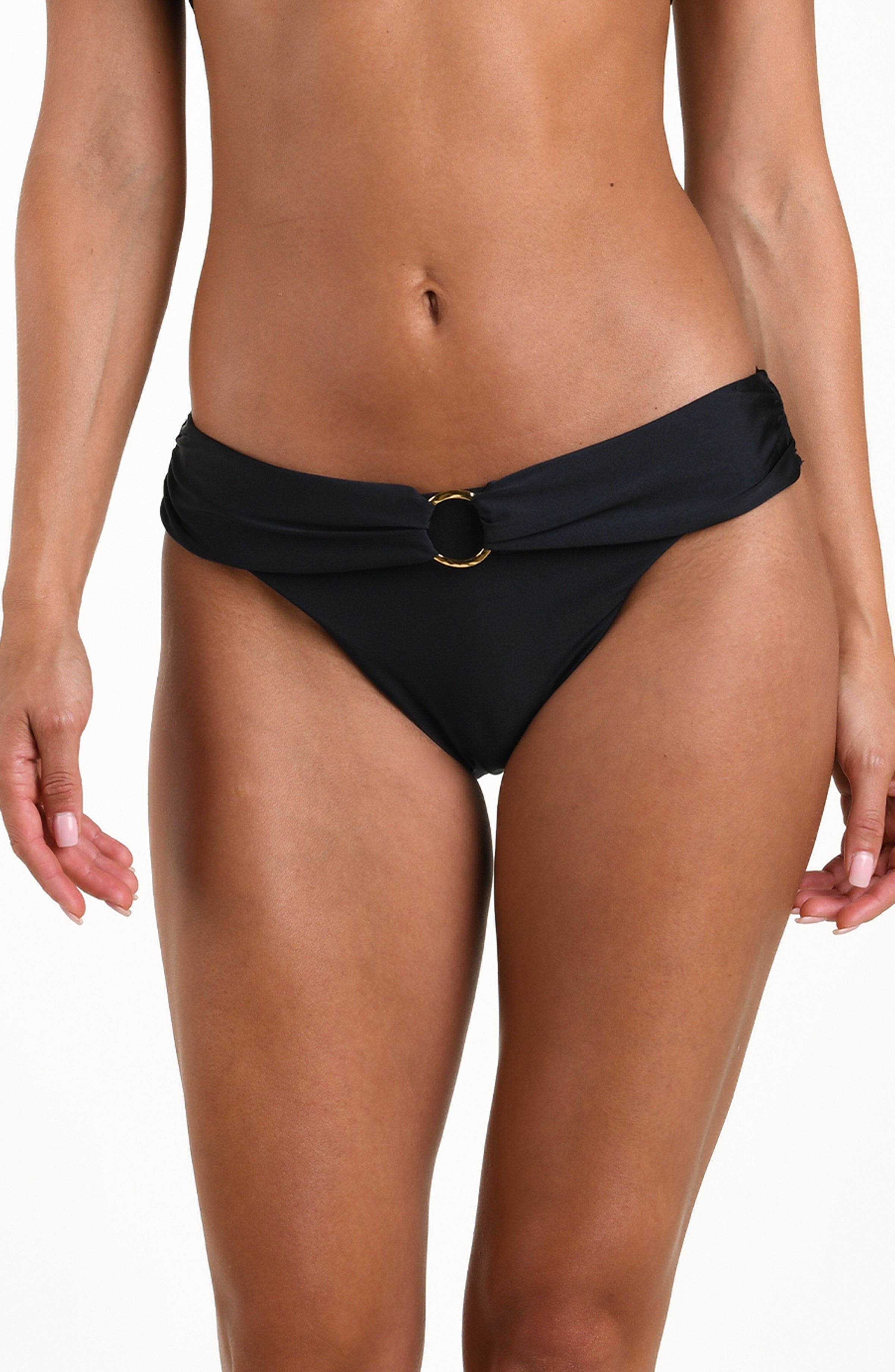 Front image of model wearing a solid black bikini bottom with a wide waistband and gold ring detail at the front. 