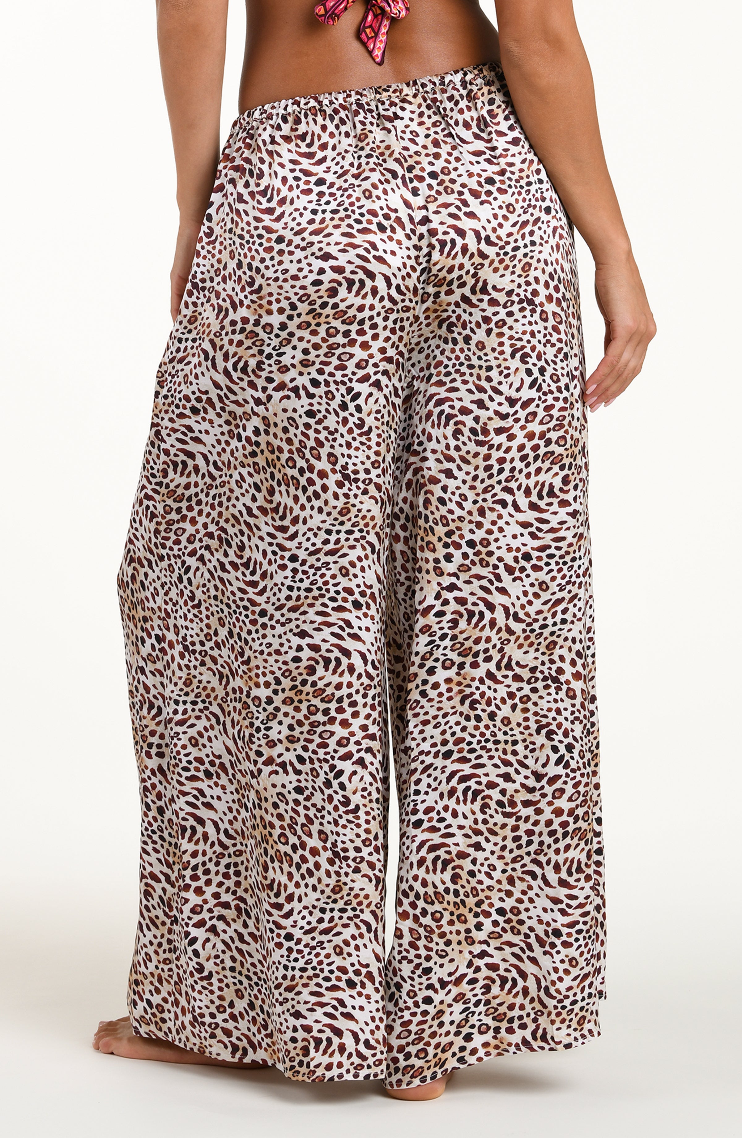 Leopard print wide-leg pants worn by a person on a white background