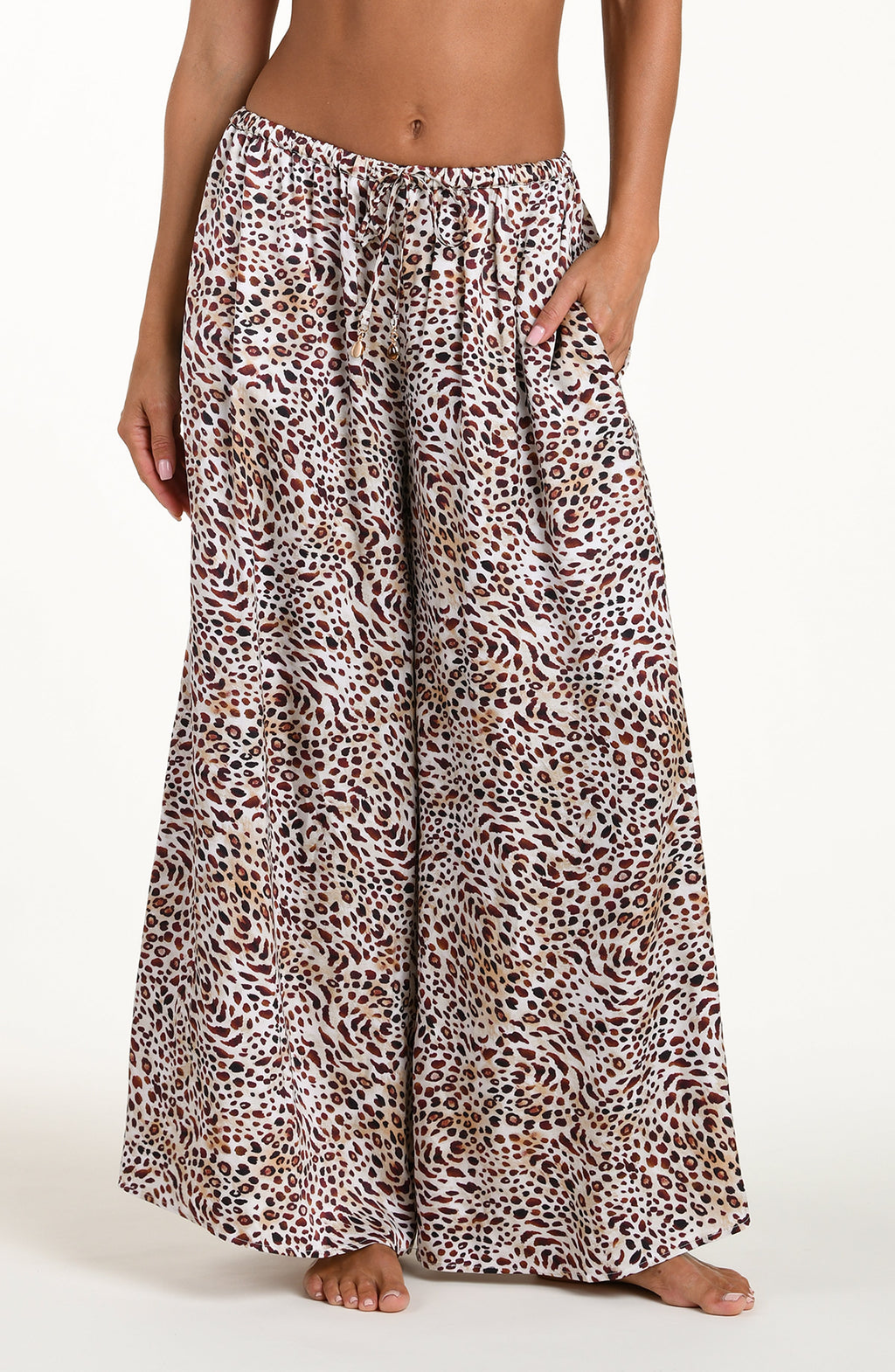 Leopard print pants worn by a person on a white background