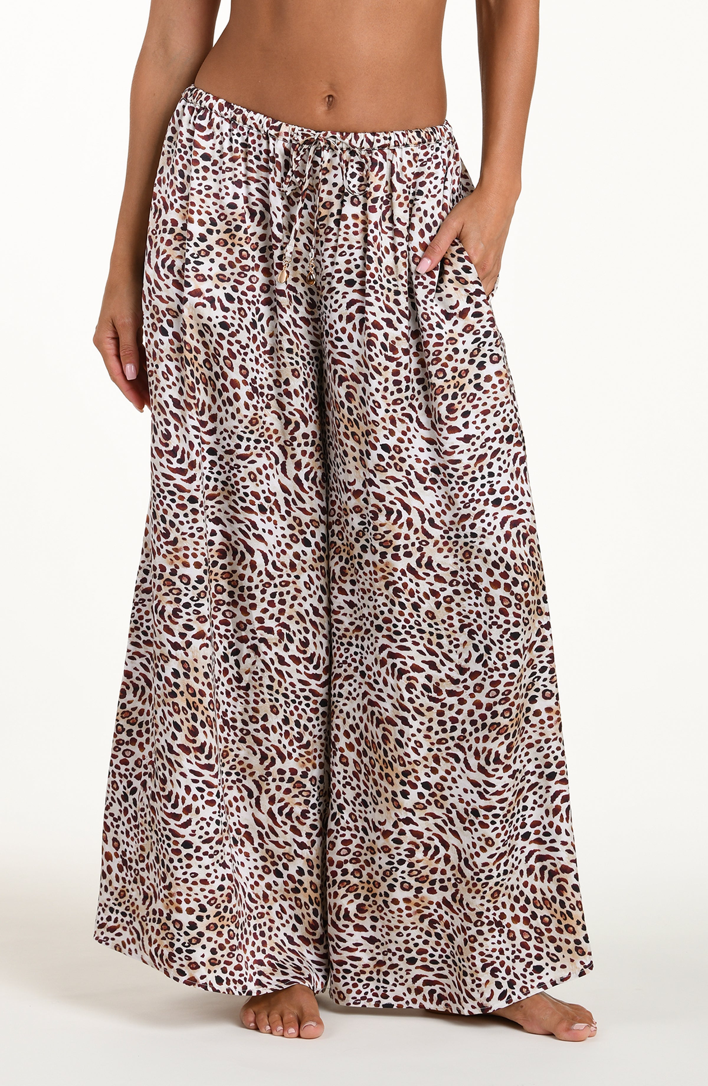 Leopard print pants worn by a person on a white background