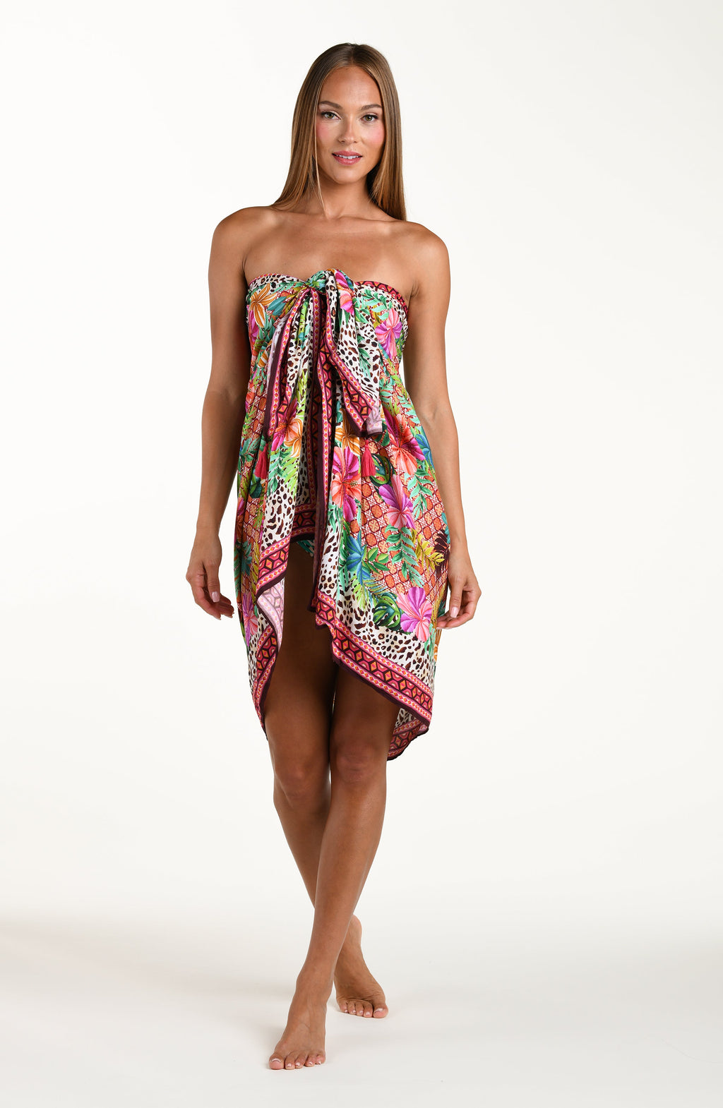 Woman wearing a colorful floral sarong on a white background