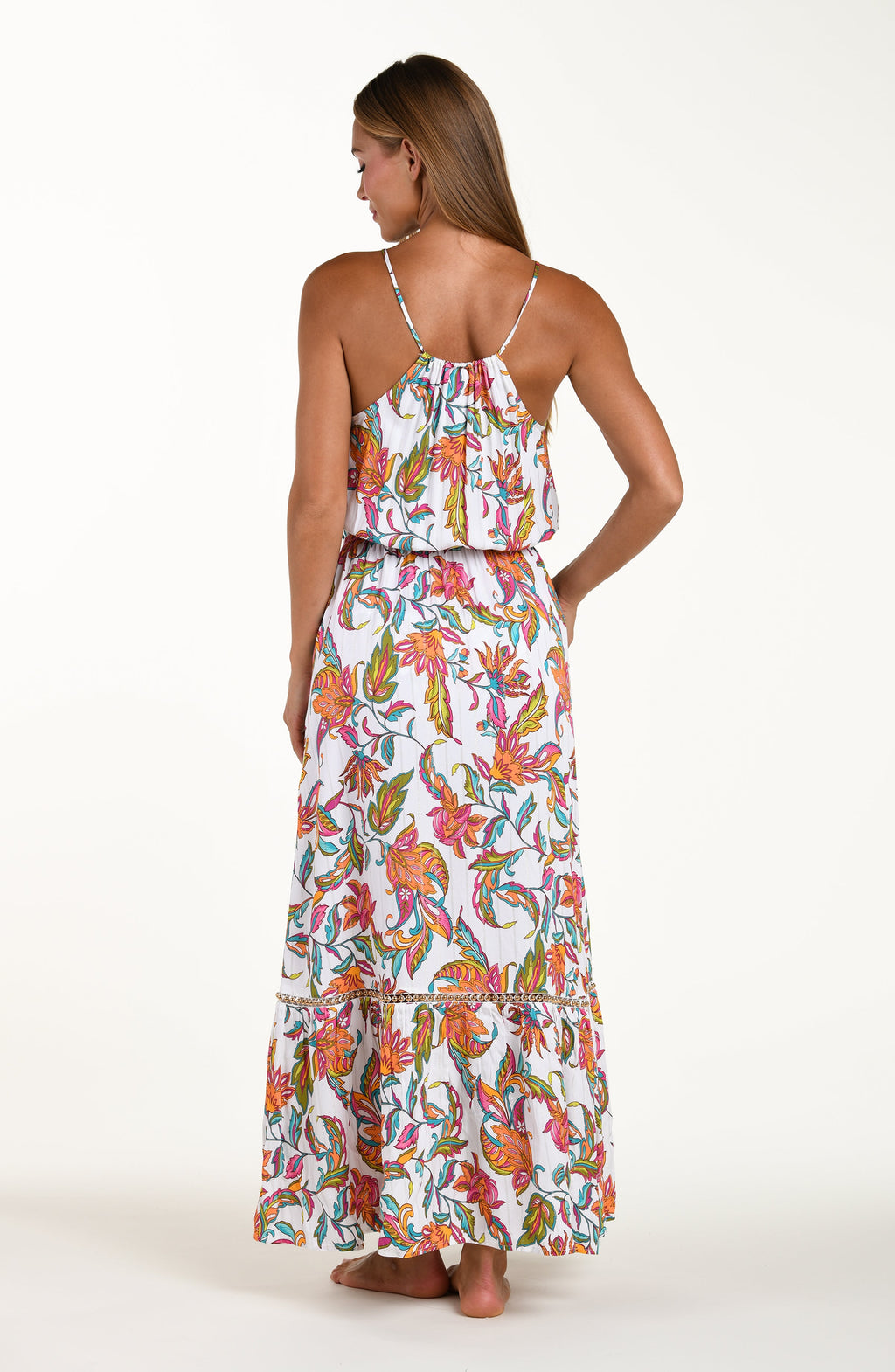 Woman wearing a colorful floral dress on a white background