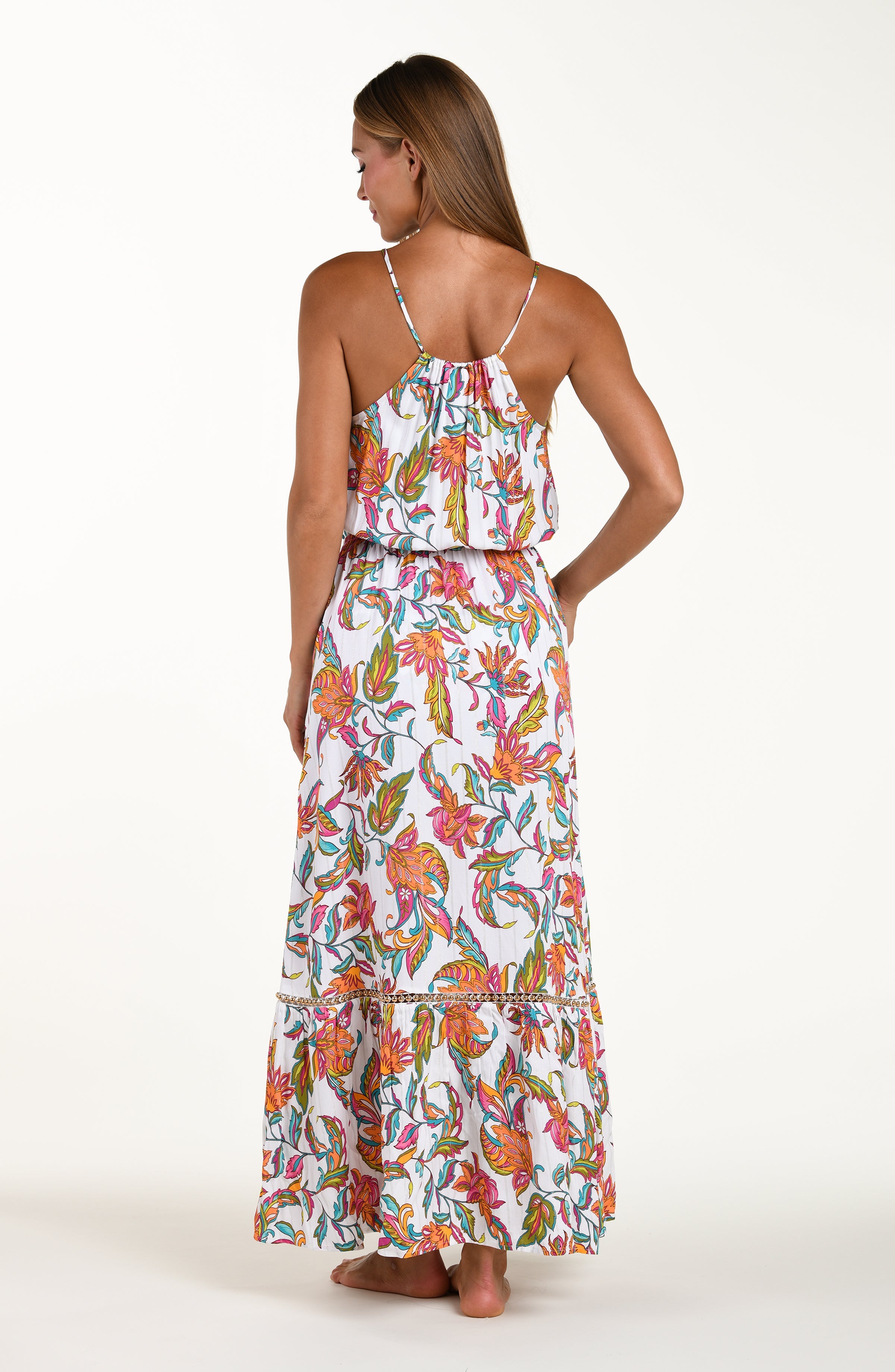 Woman wearing a colorful floral dress on a white background