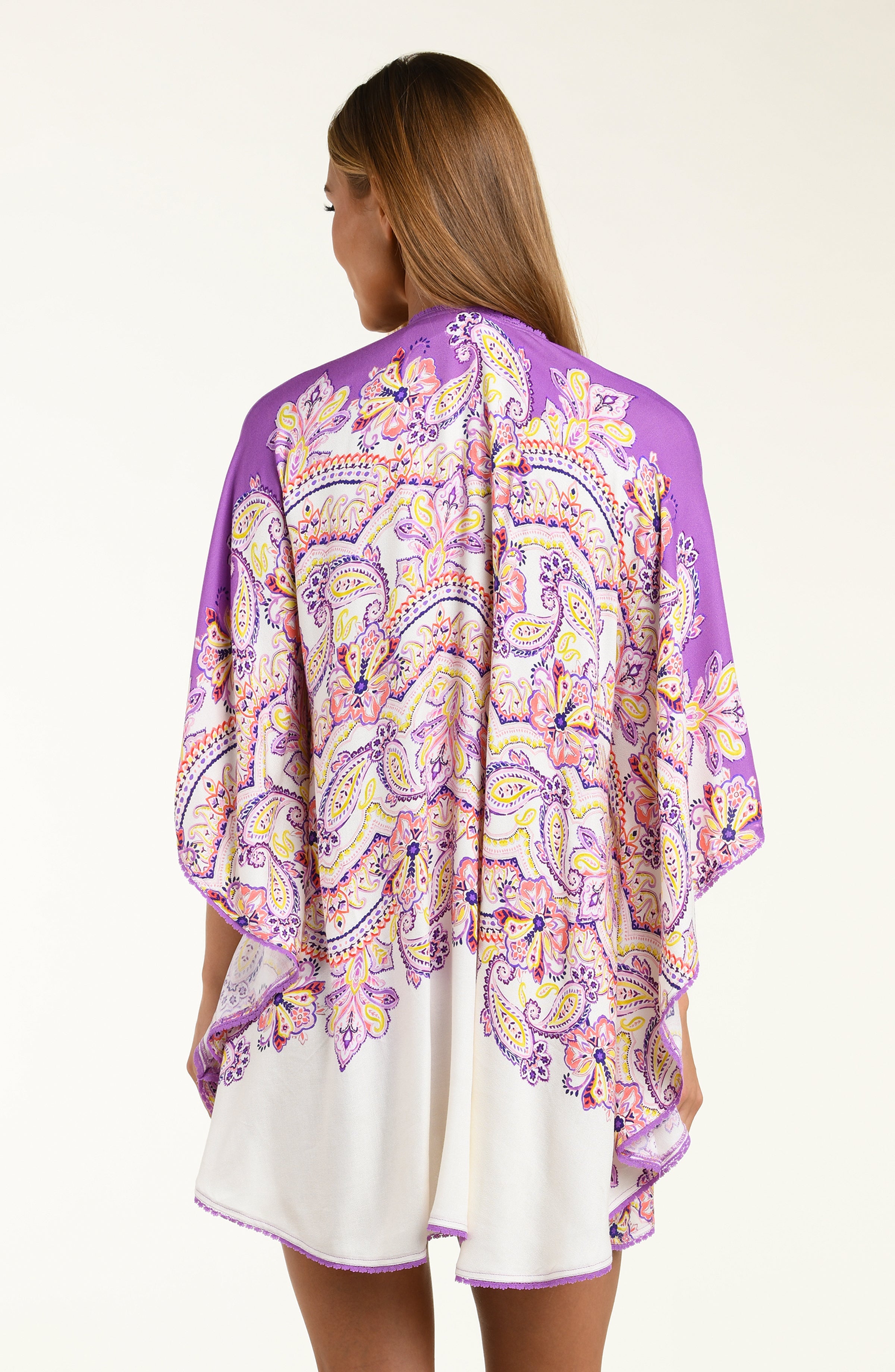Woman wearing a purple patterned kimono over a white background