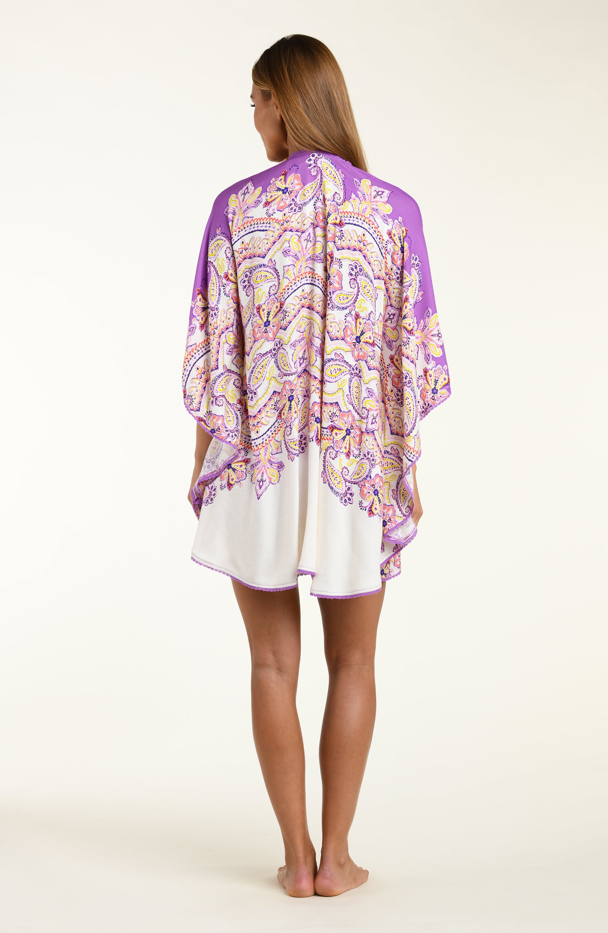Woman wearing a purple patterned kimono over a white background