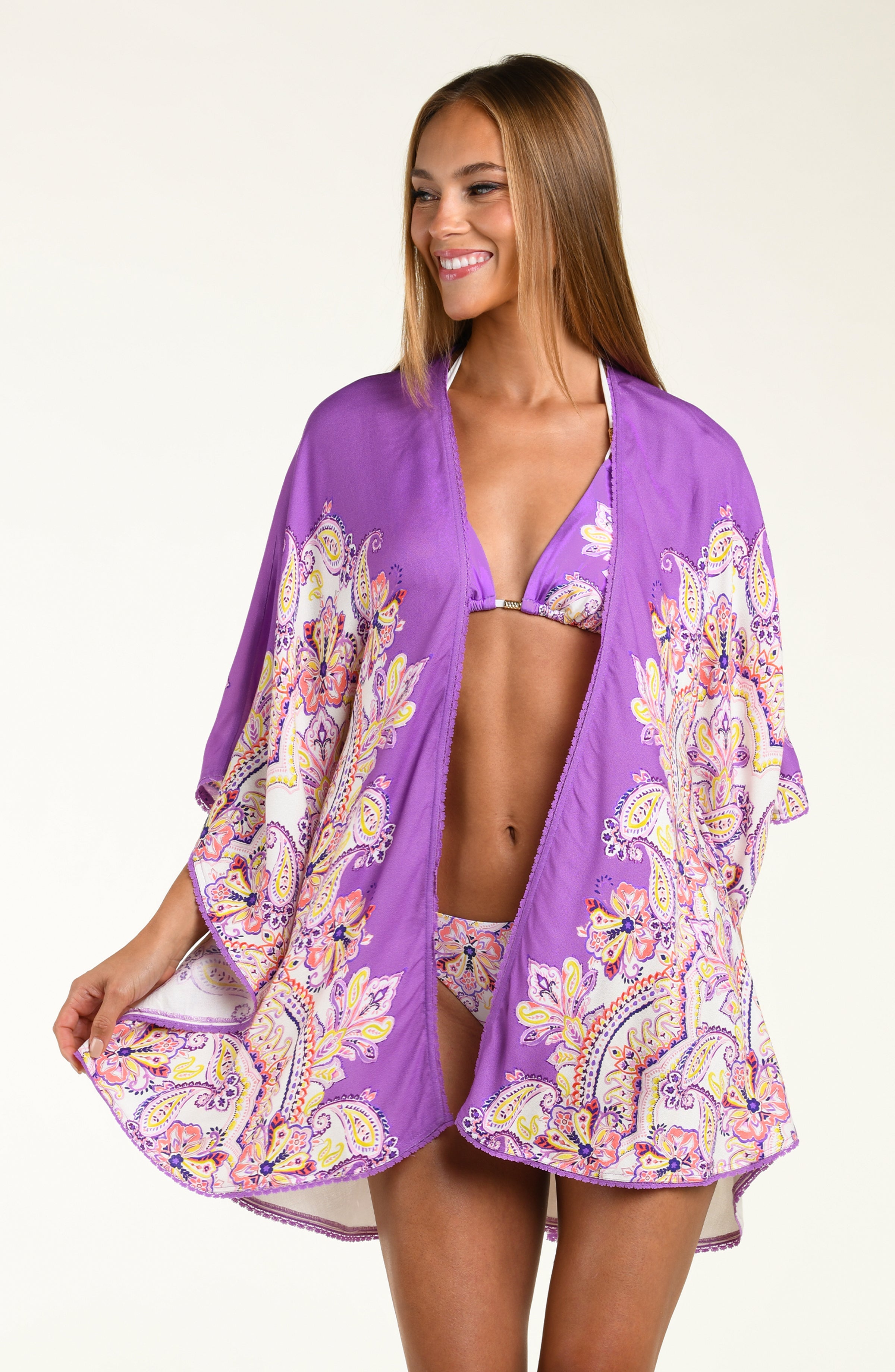 Woman wearing a purple patterned kimono over a white background