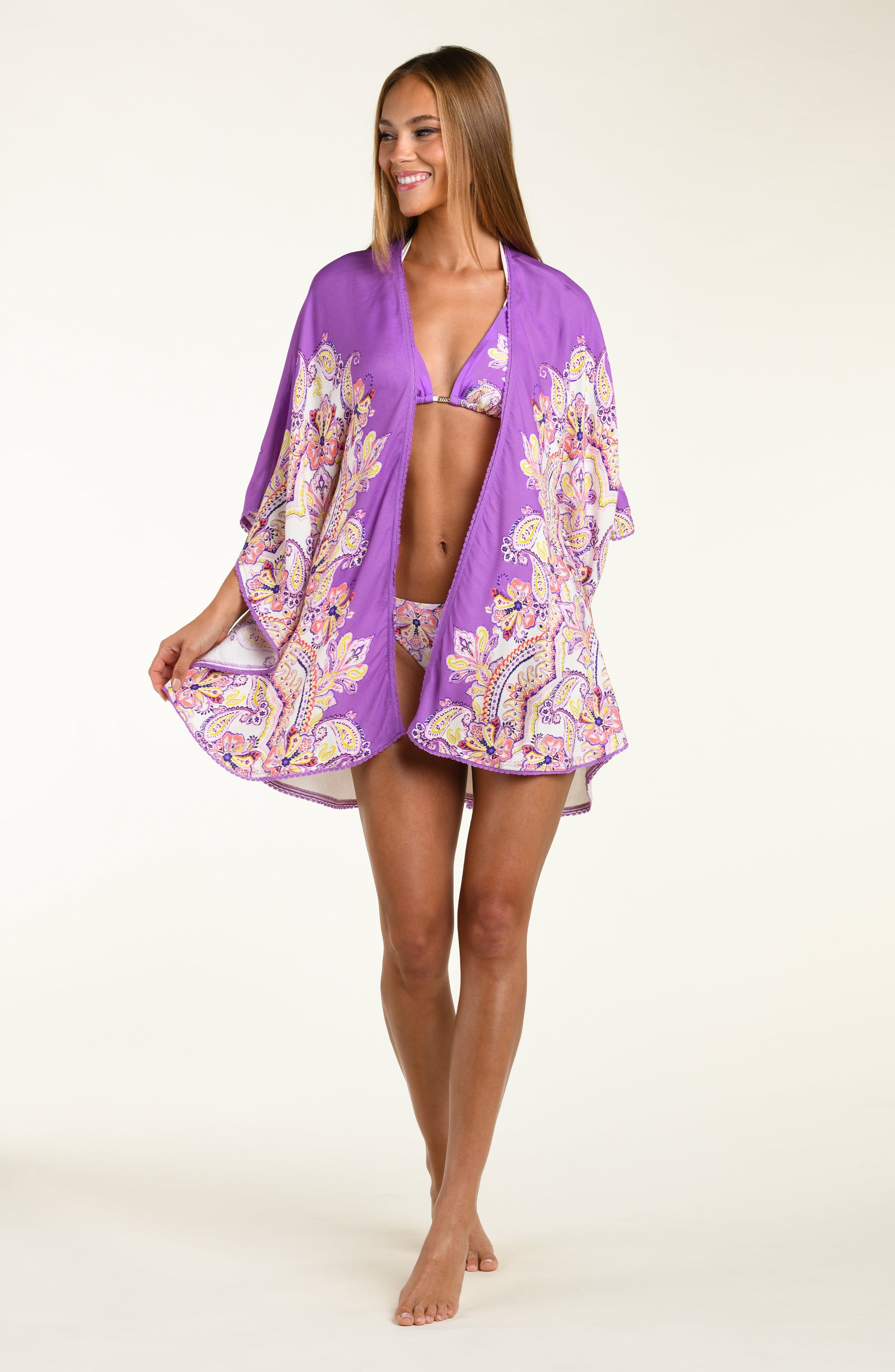 Woman wearing a purple patterned kimono over a white background