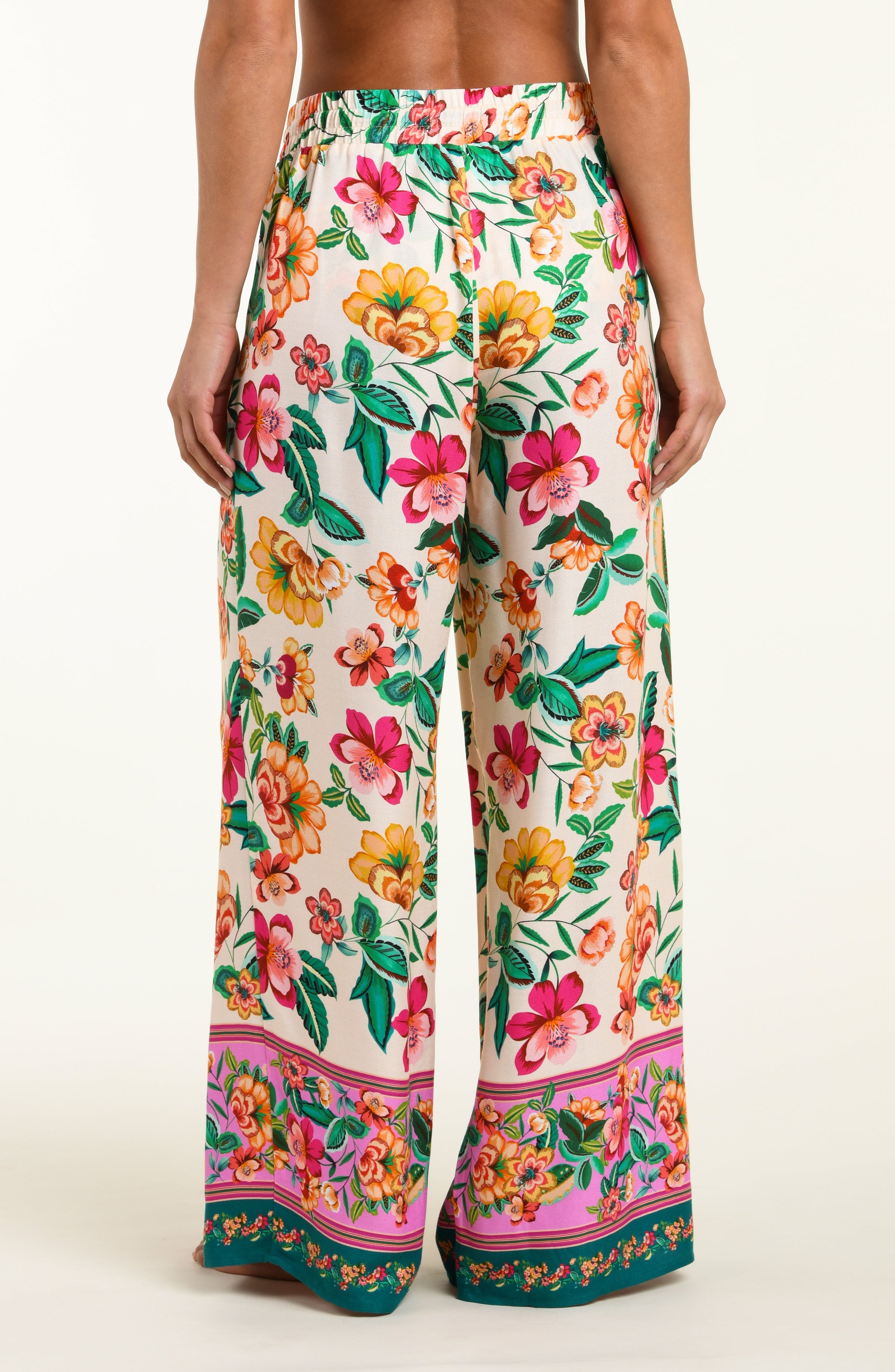 Floral patterned pants with a colorful border on a white background