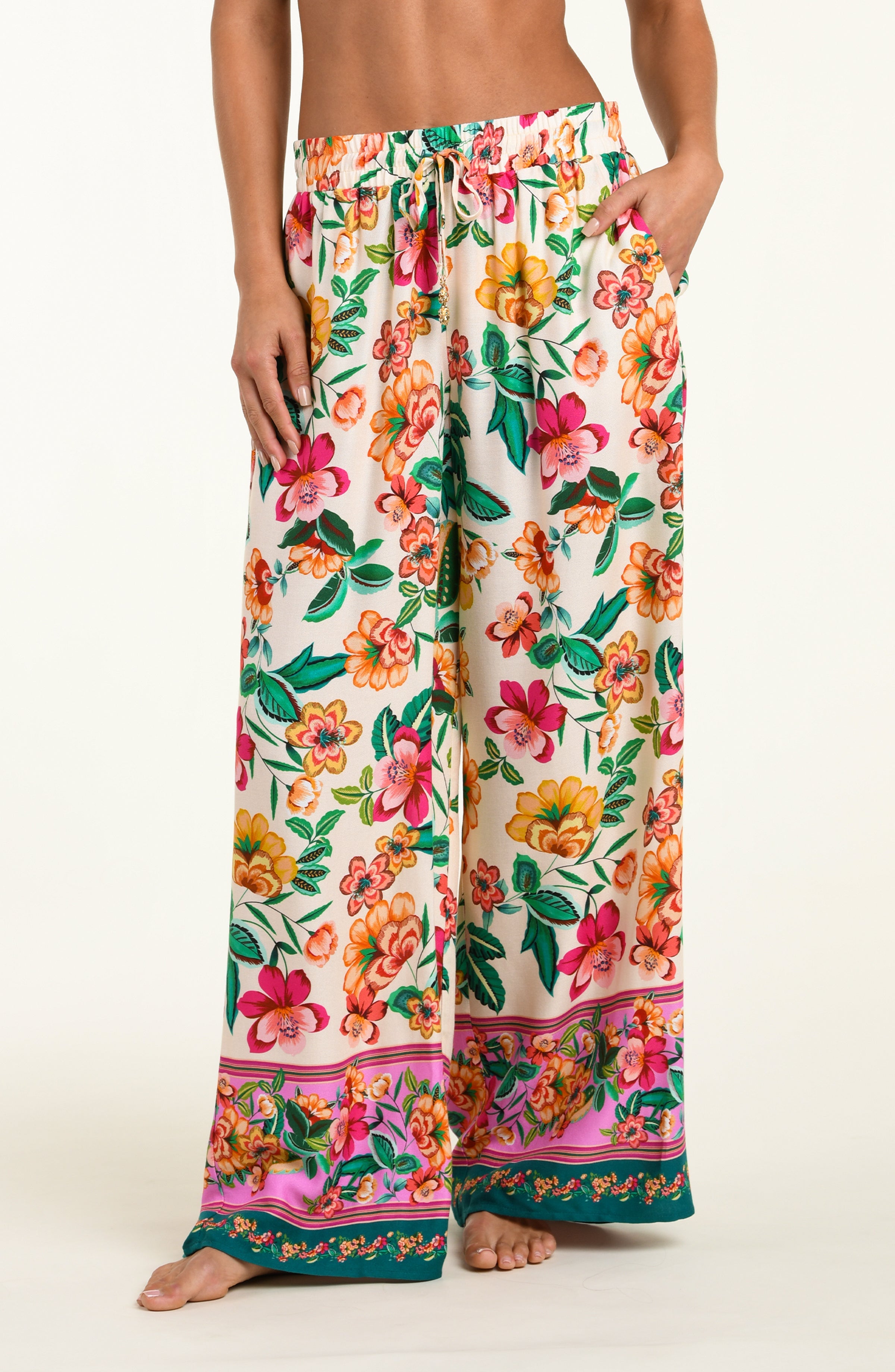 Floral patterned pants worn by a person on a white background