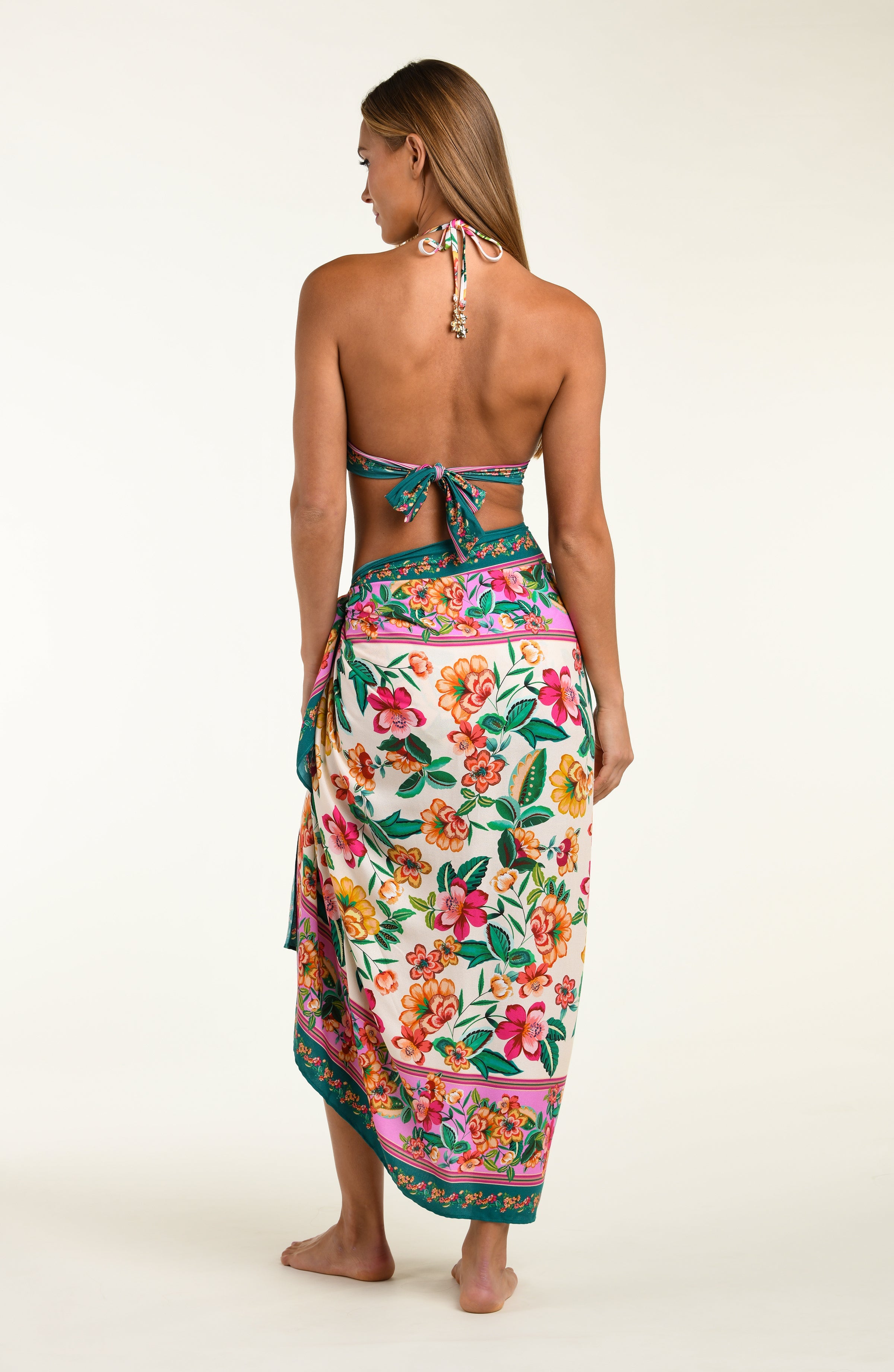 Woman wearing a multicolored floral sarong with a white background