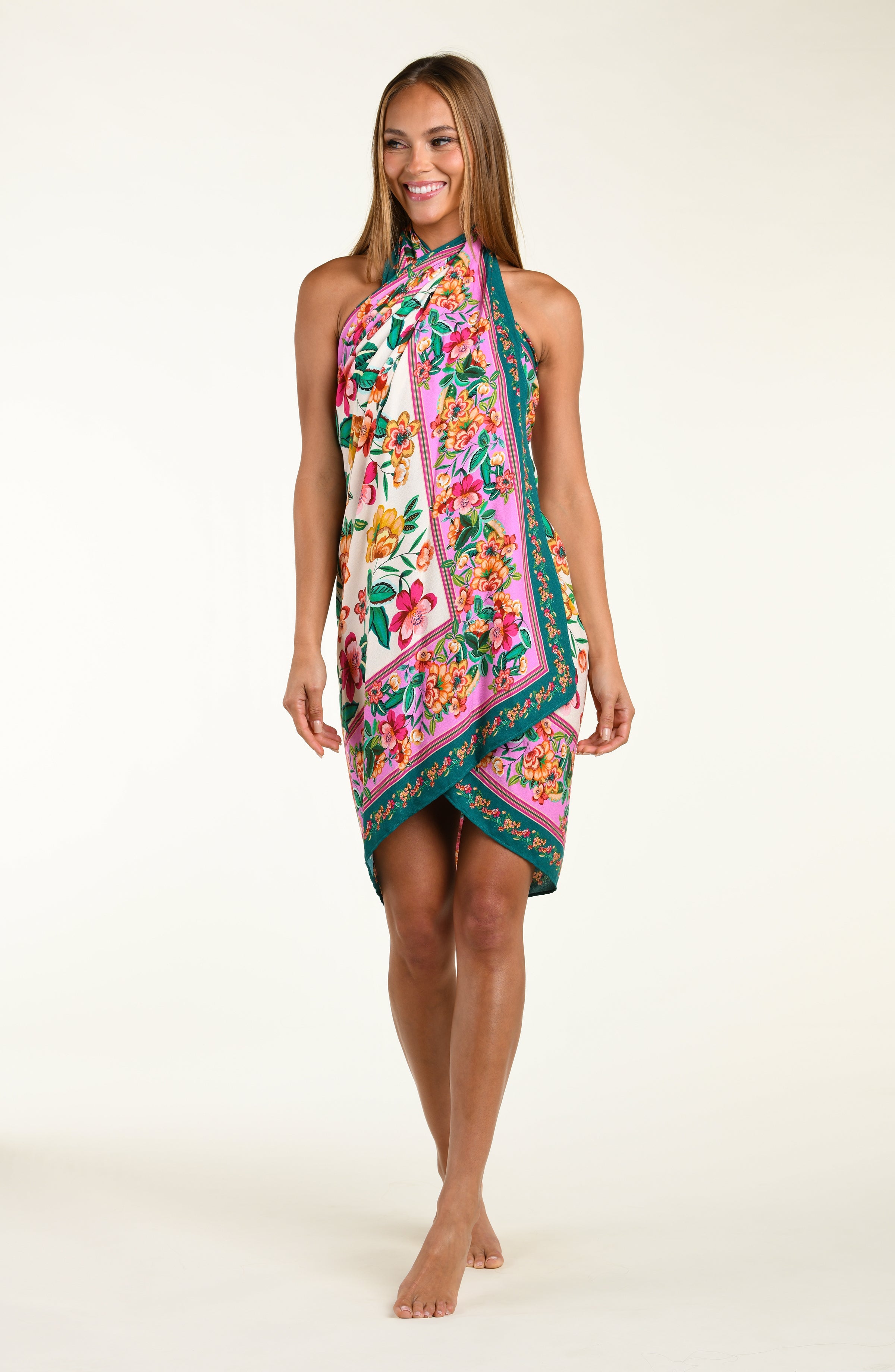 Woman wearing a colorful floral sarong on a white background