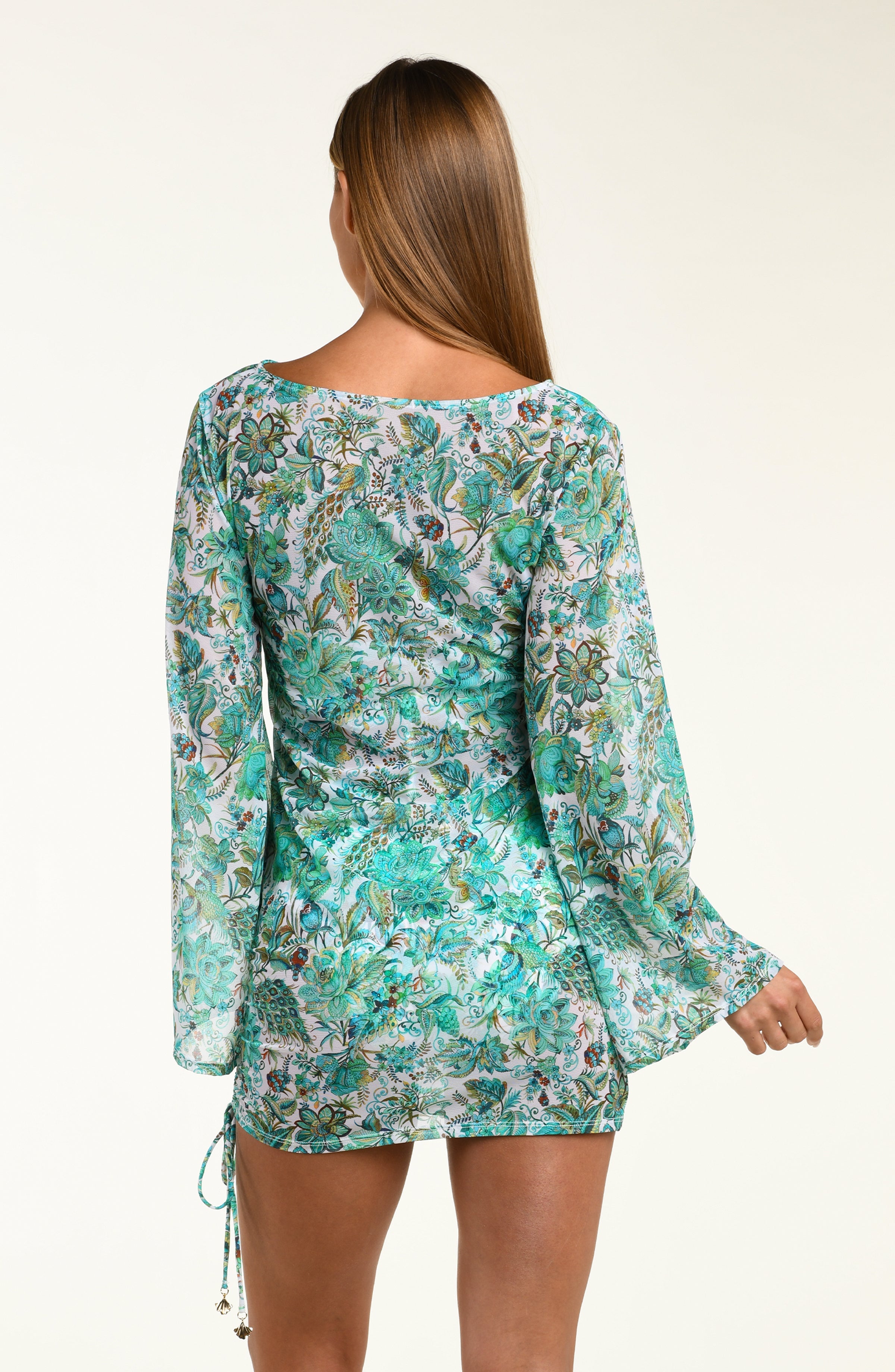 Woman wearing a floral tunic with bell sleeves on a white background