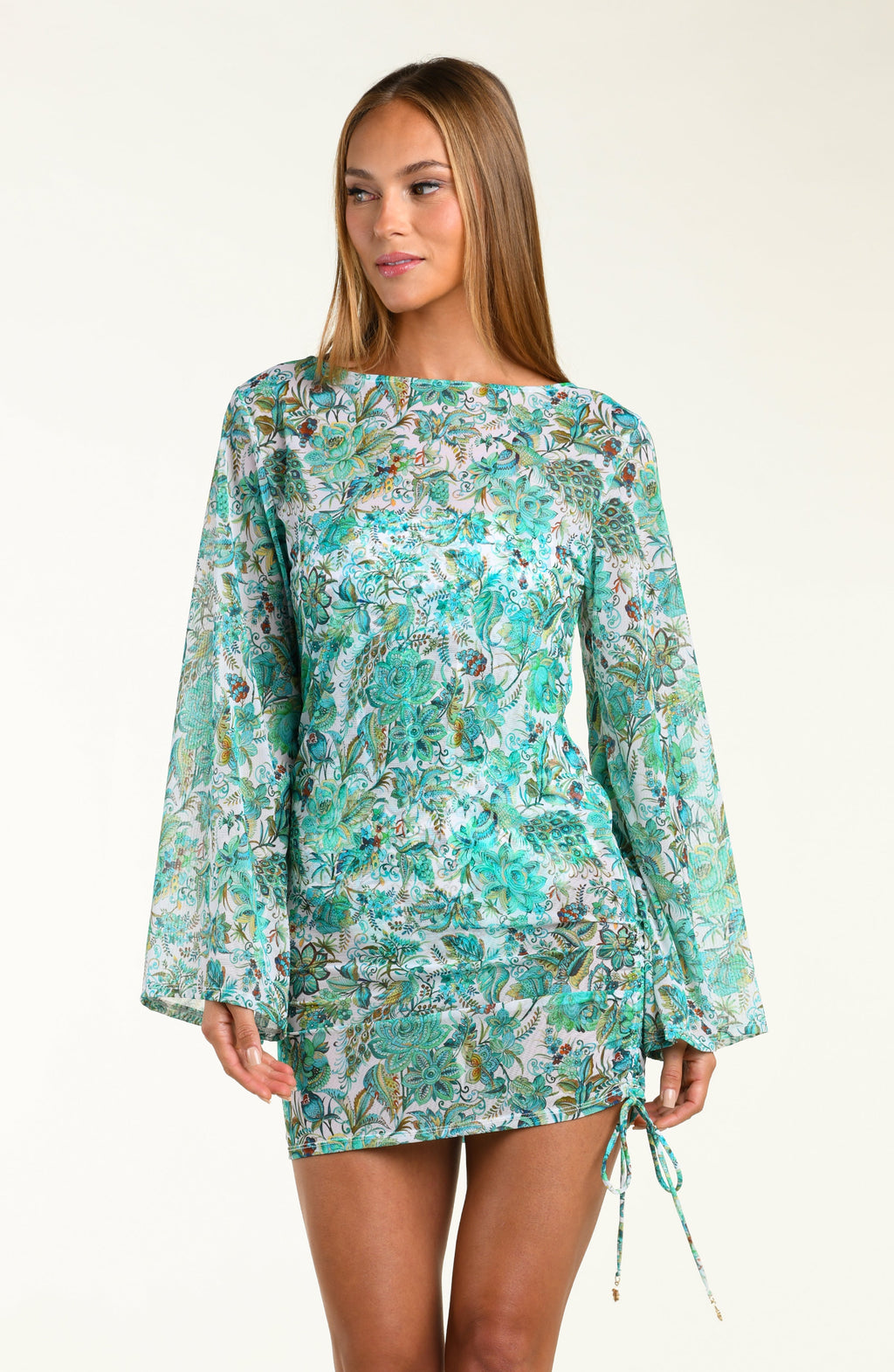 Woman wearing a floral tunic with bell sleeves on a white background