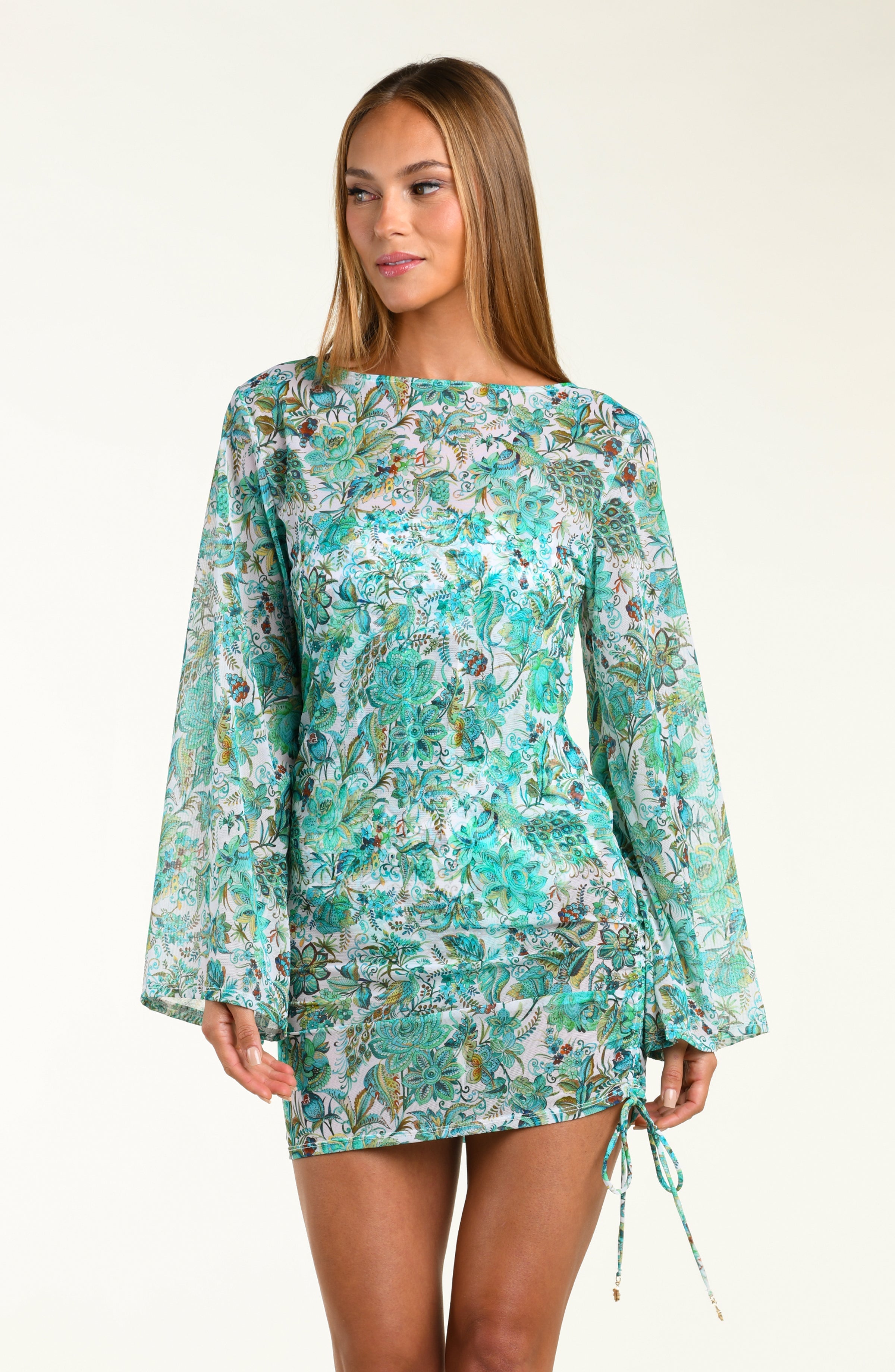 Woman wearing a floral tunic with bell sleeves on a white background