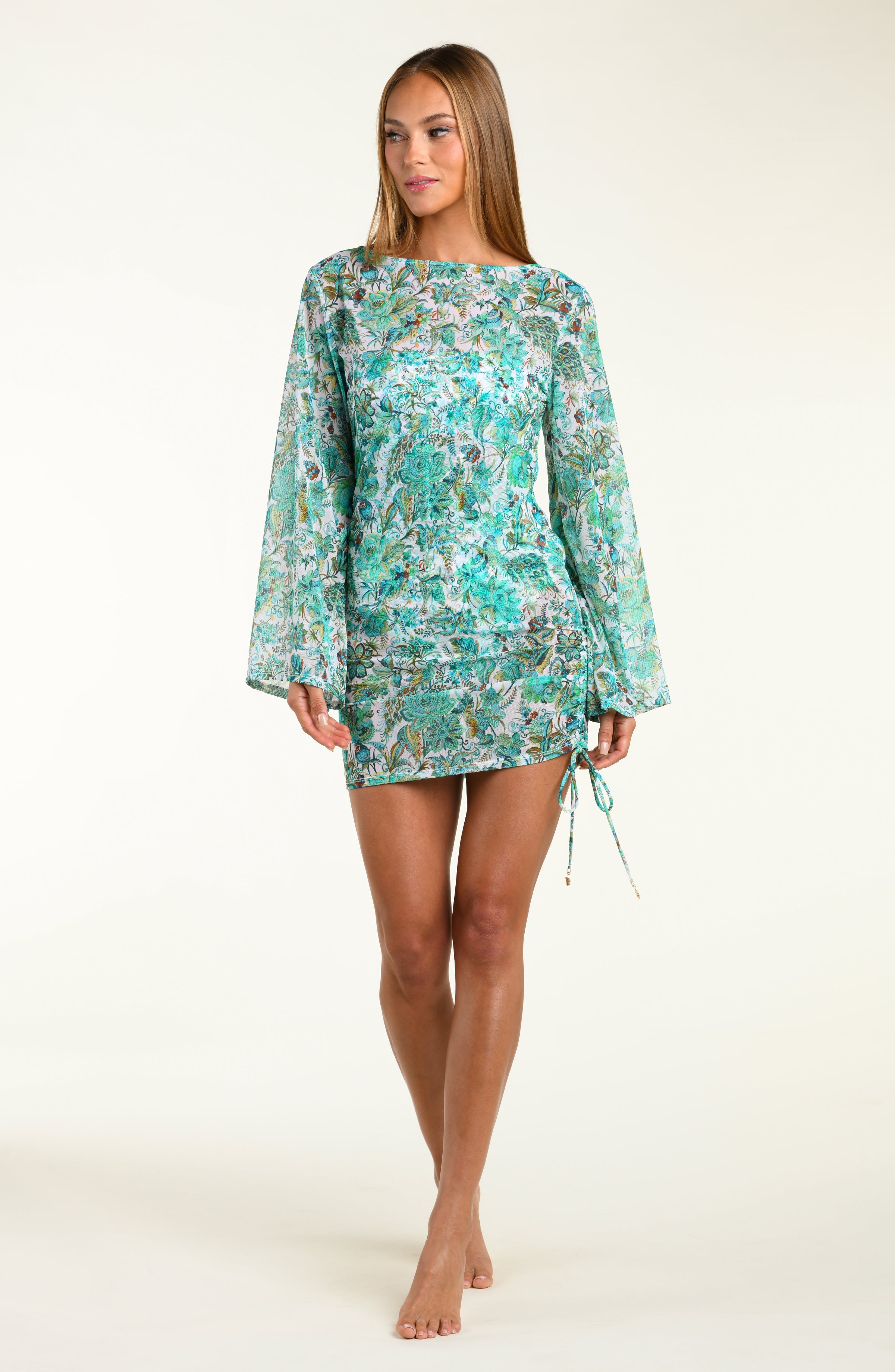 Woman wearing a floral tunic with bell sleeves on a white background