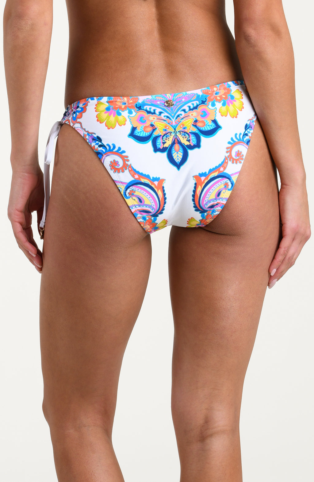 Woman wearing a multicolored bikini bottom against a white background.