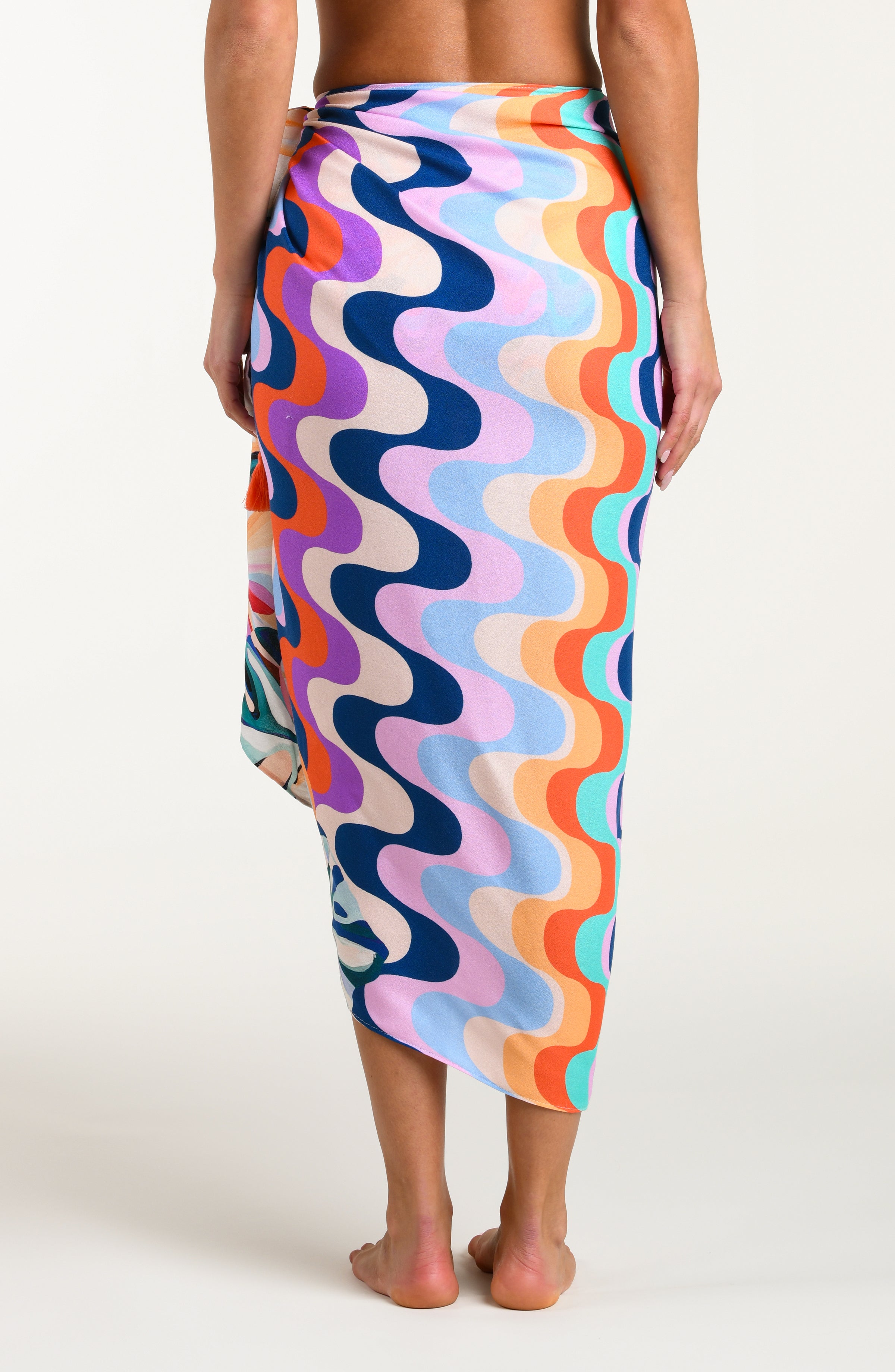Multicolored patterned sarong being worn by a person on a white background