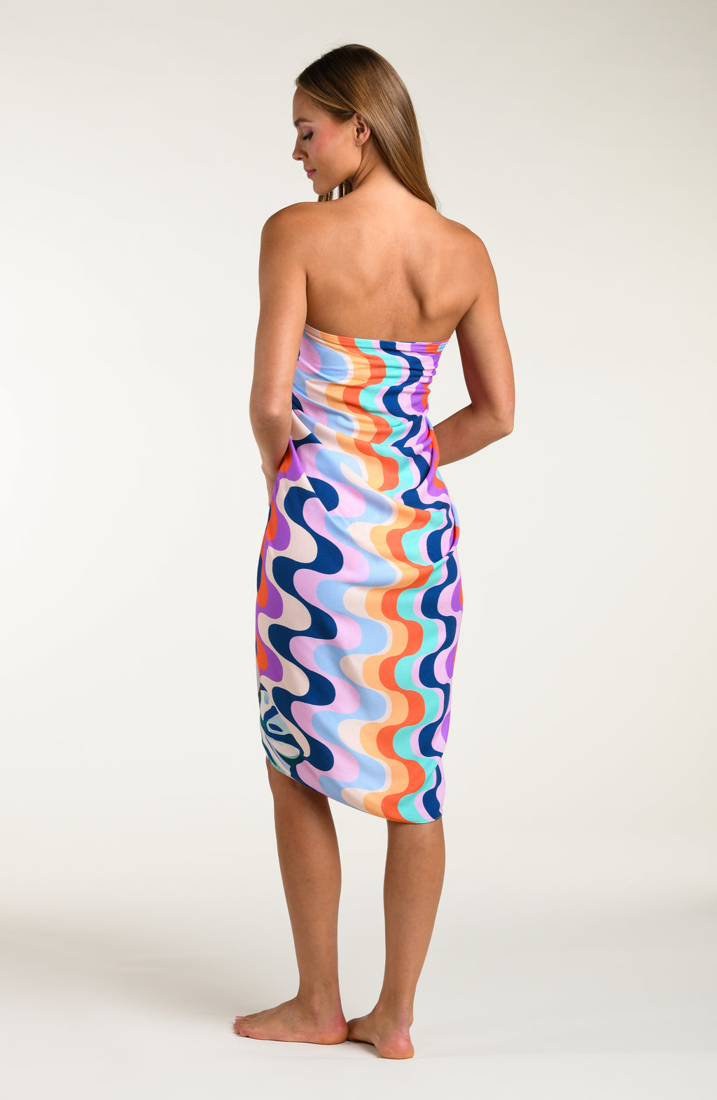 Multicolored patterned sarong being worn by a person on a white background