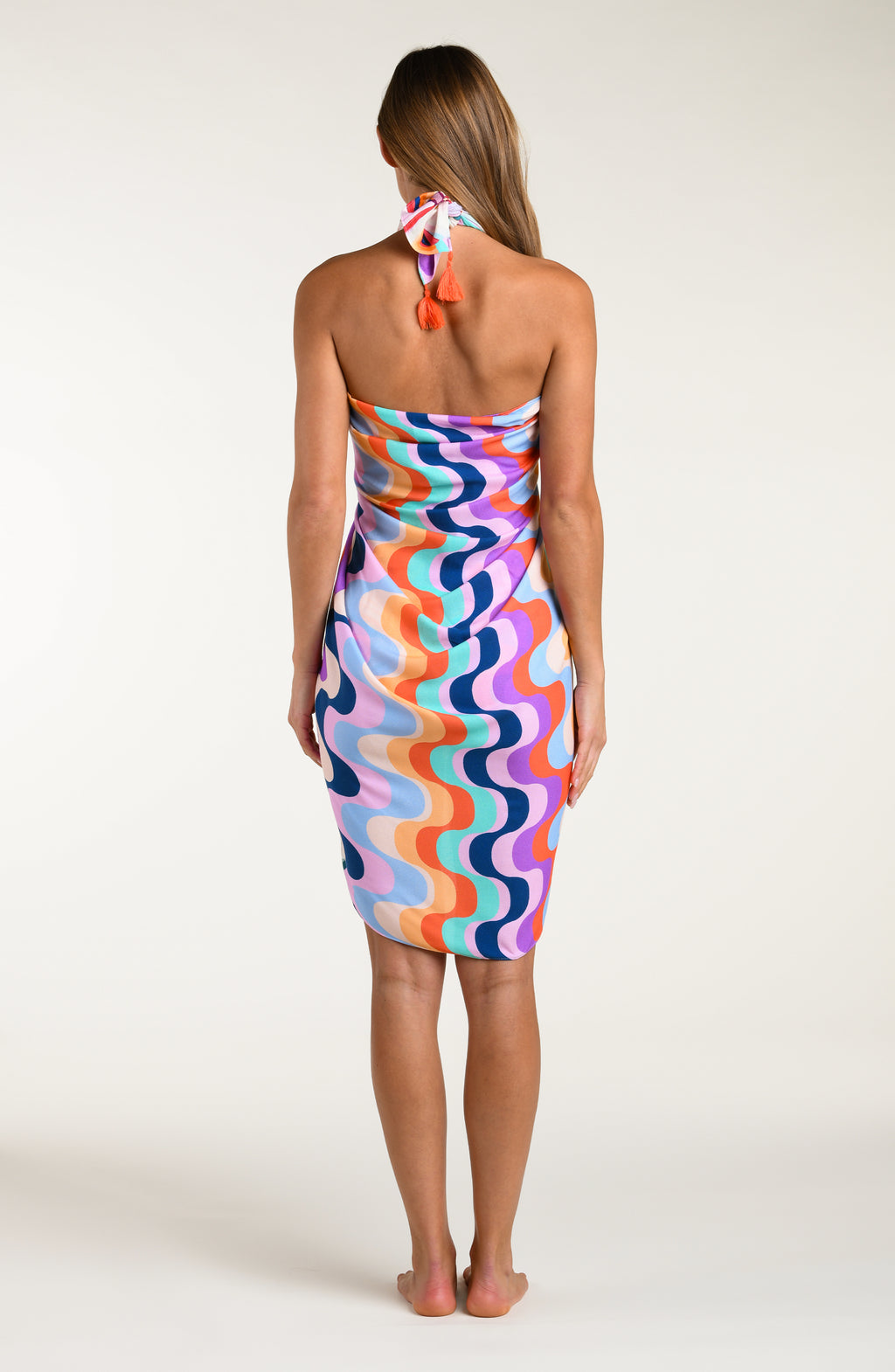 Multicolored patterned sarong being worn by a person on a white background
