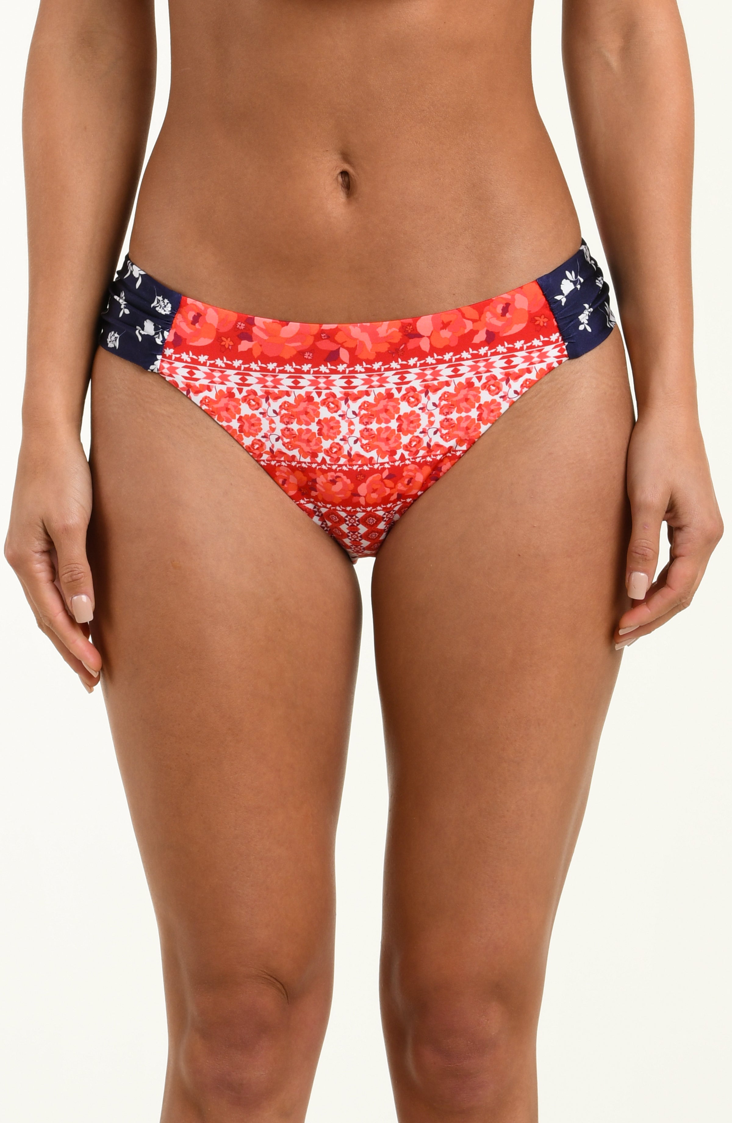 Red and white patterned bikini bottom on a plain background