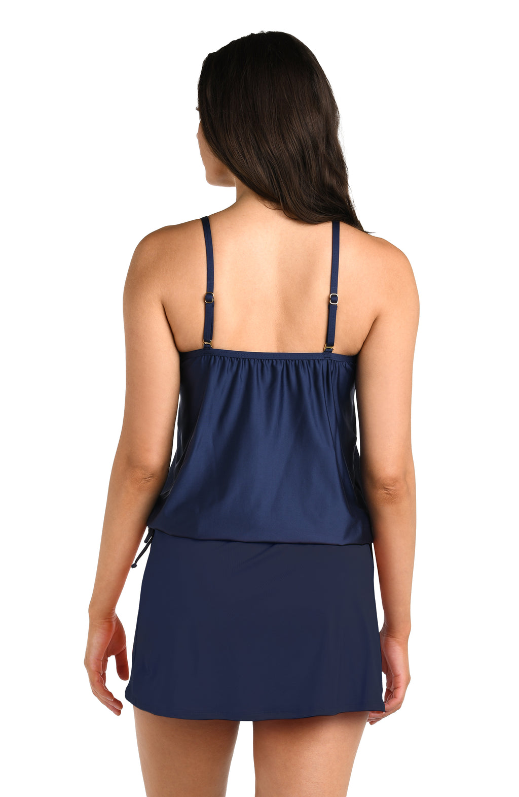 Woman wearing a navy blue tankini top with thin straps and matching bottoms against a white background.