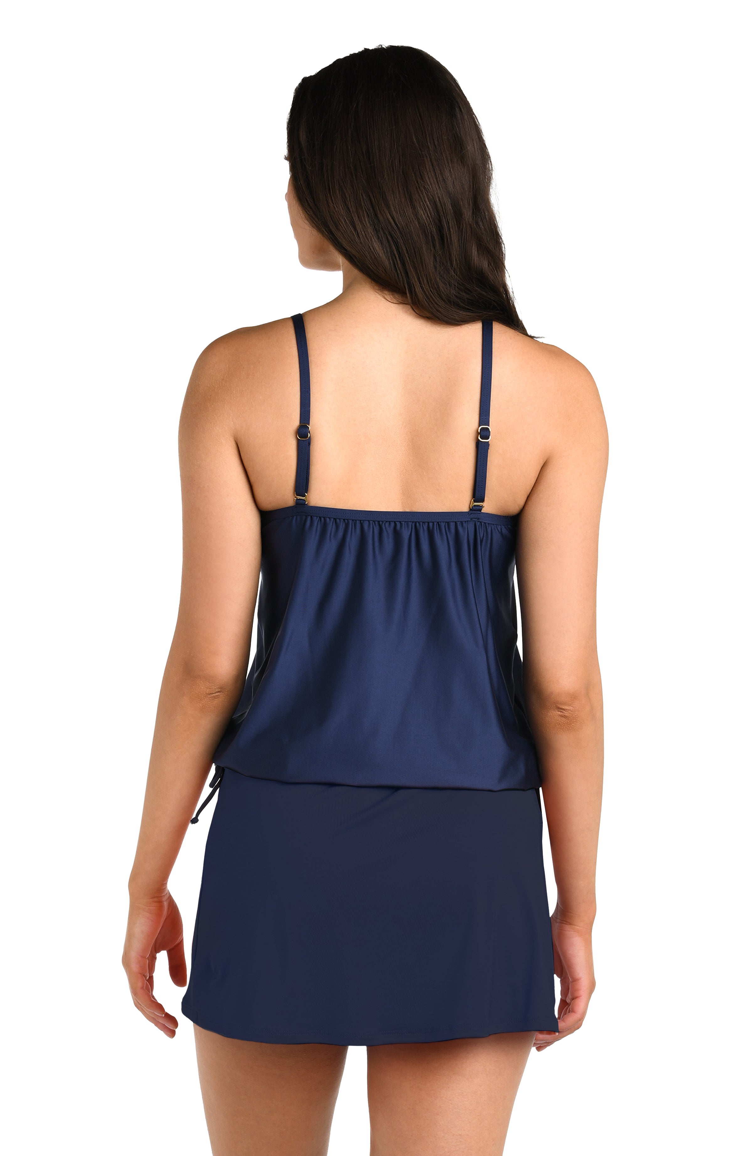 Woman wearing a navy blue tankini top with thin straps and matching bottoms against a white background.