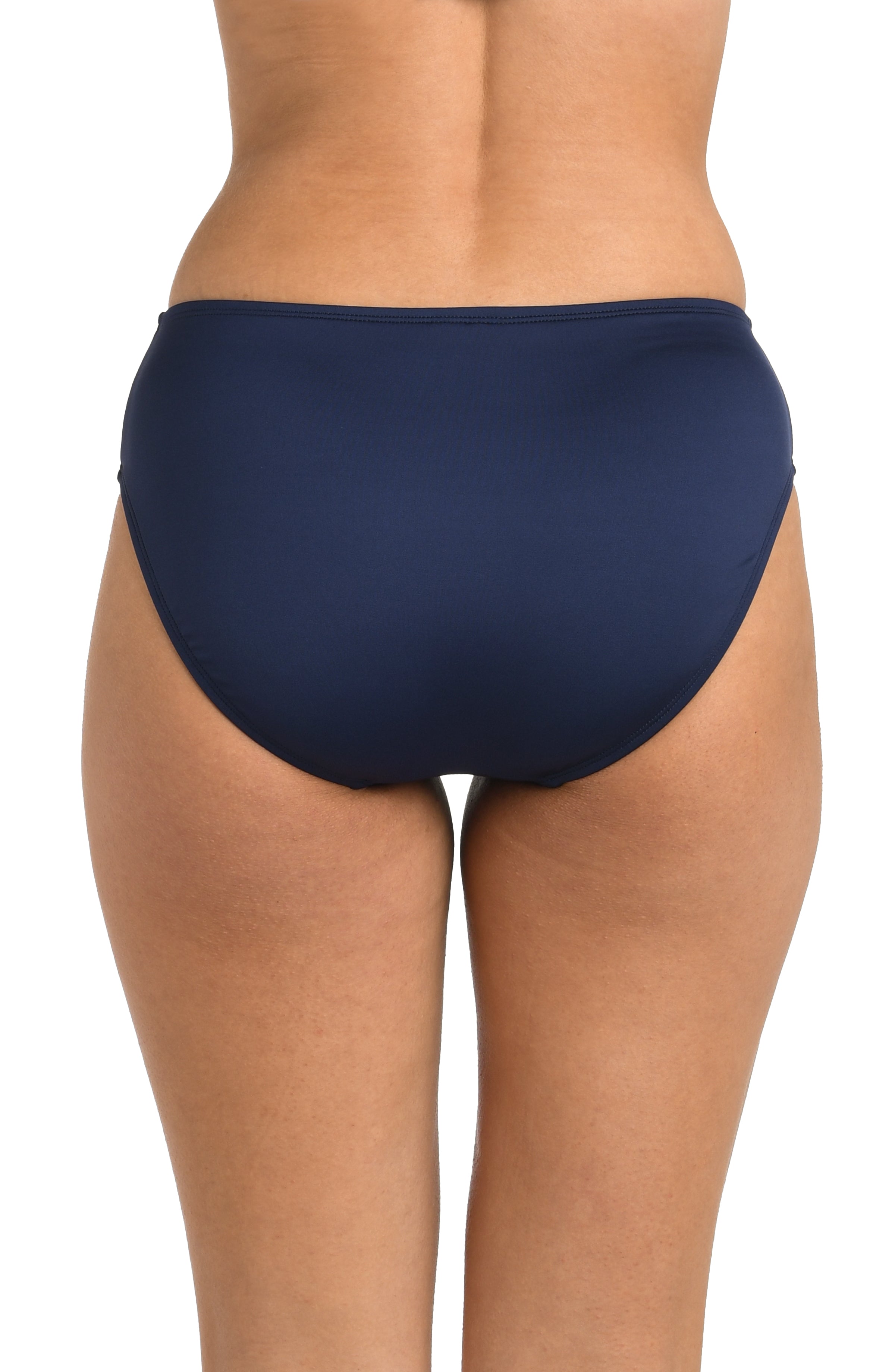 Navy blue bikini bottom worn by a person on a white background