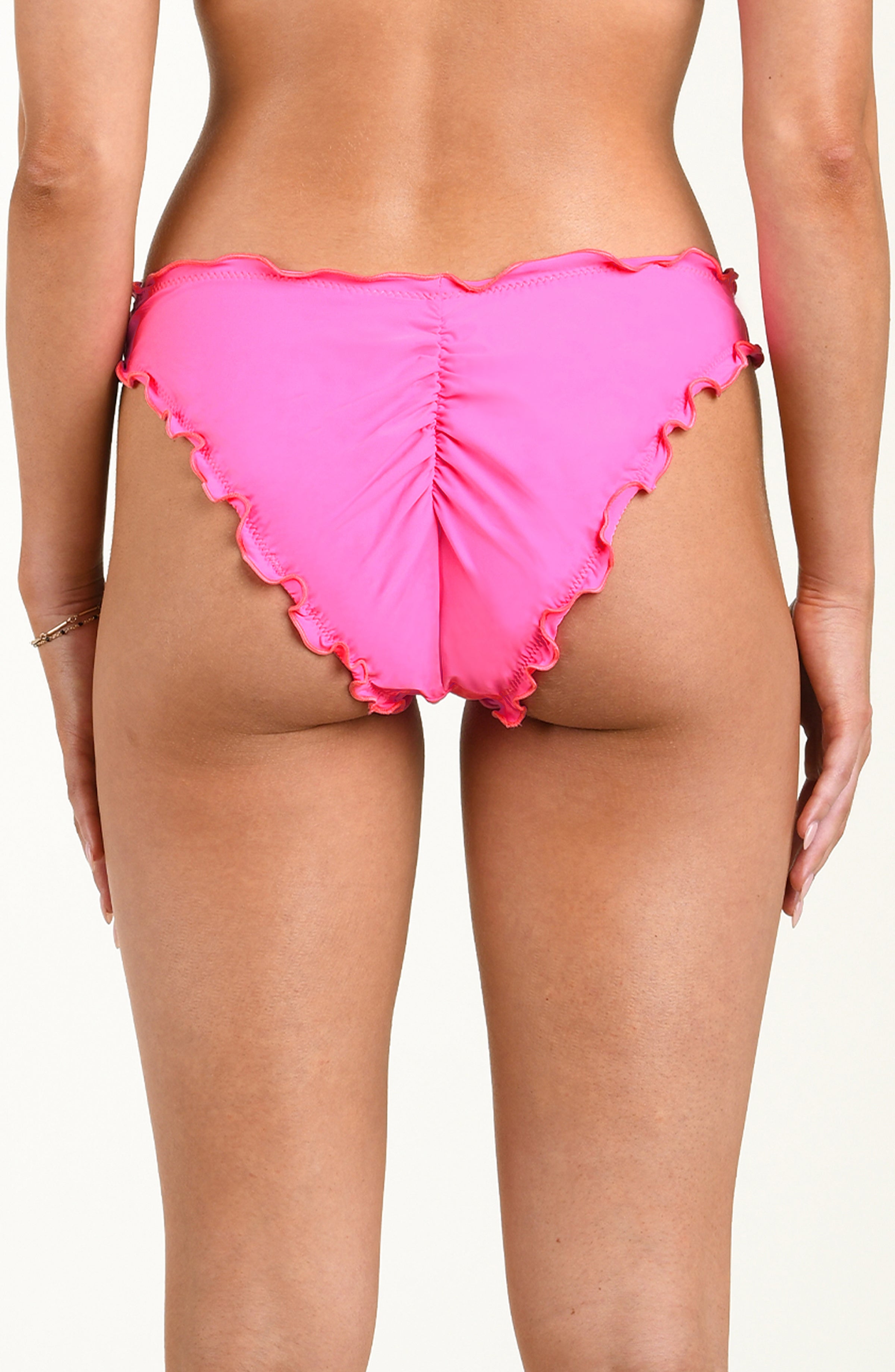 Pink bikini bottom with ruffled edges on a neutral background
