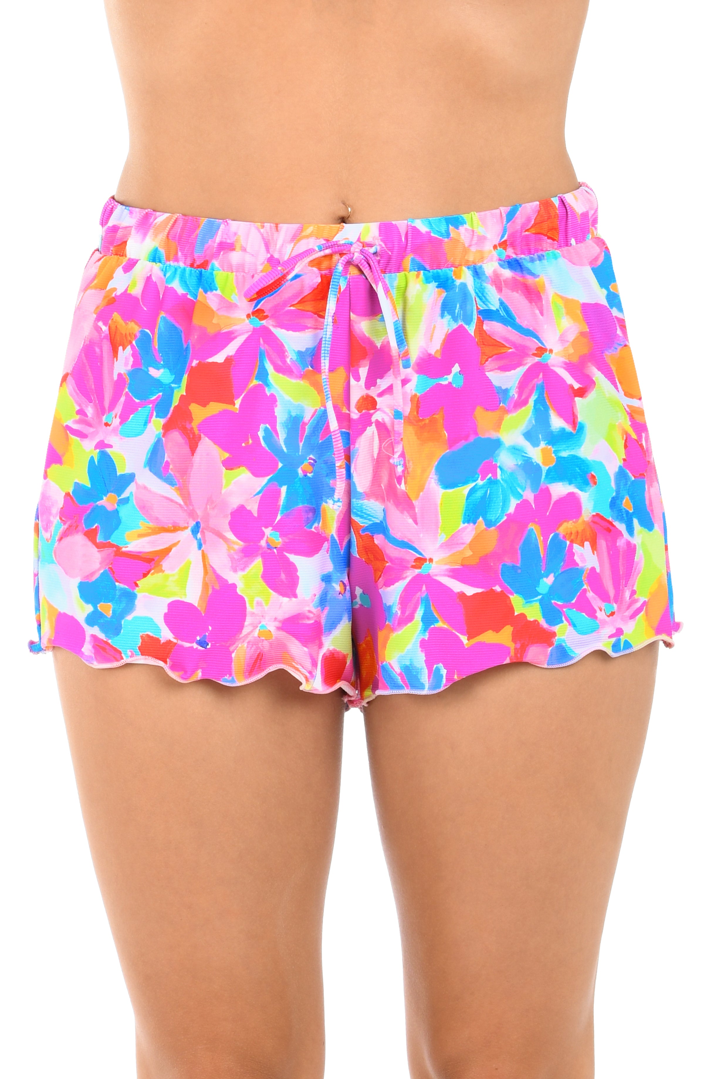 Colorful floral shorts worn by a person on a white background