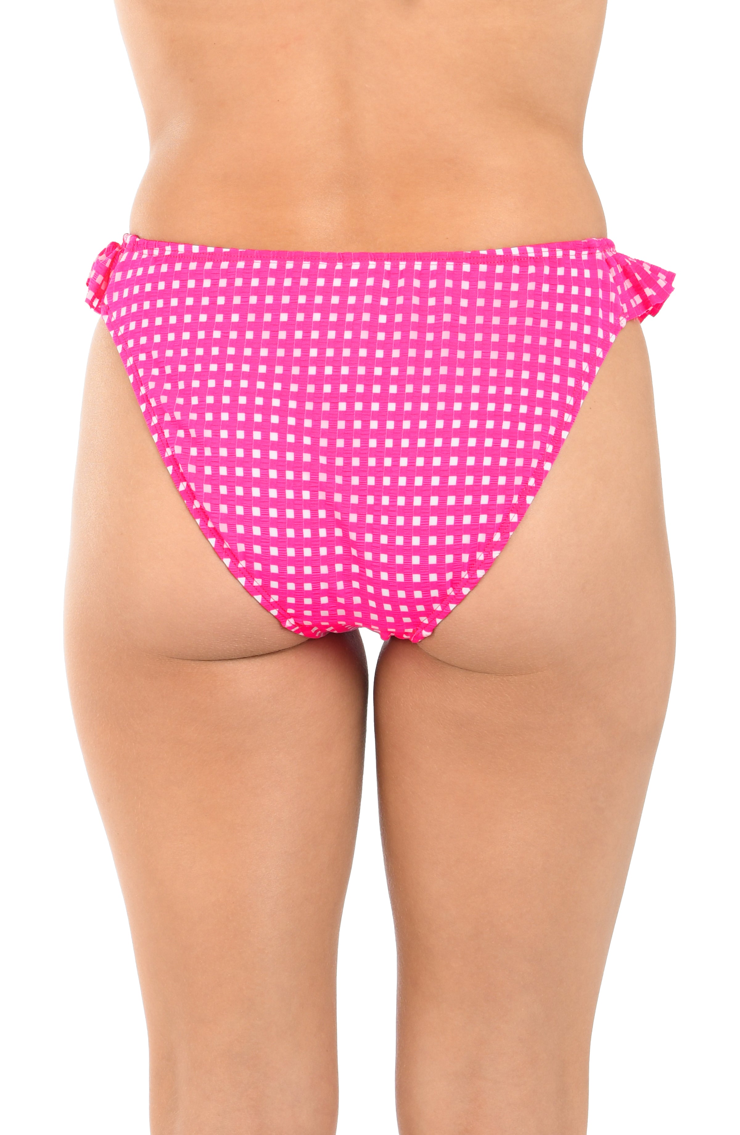 Pink polka dot bikini bottom on a white background