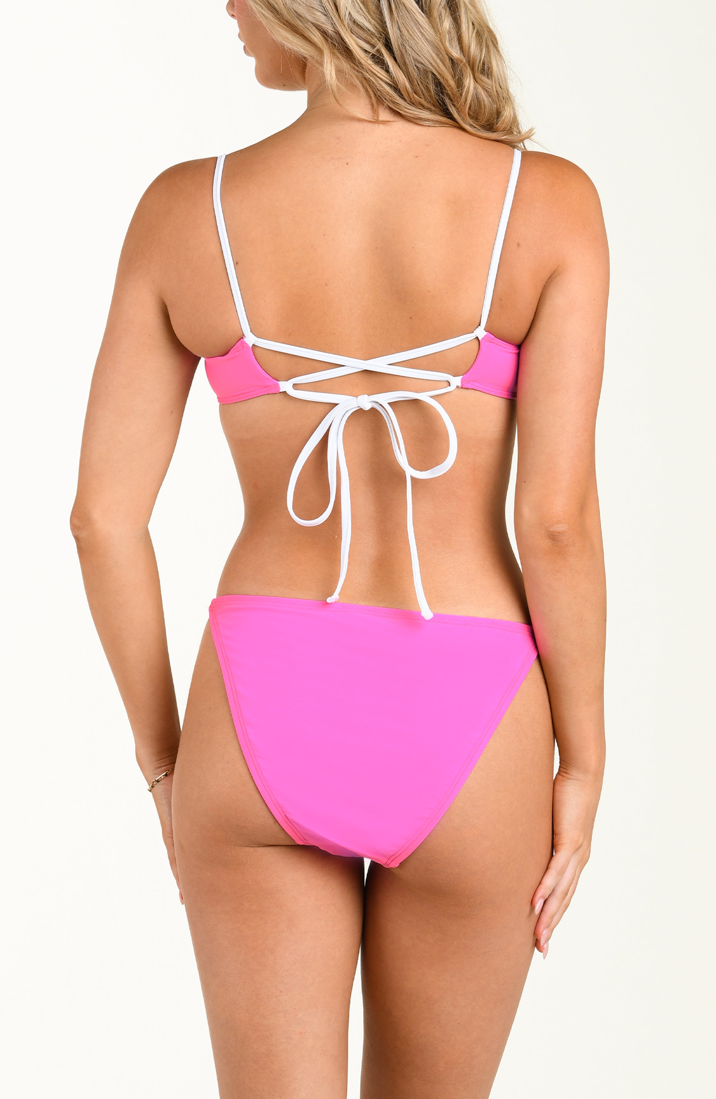 Pink bikini with white straps on a white background