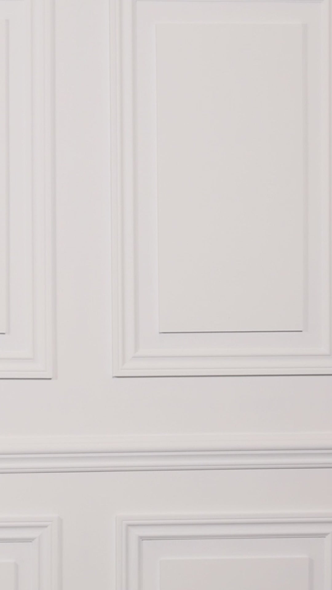 Video of a woman wearing a multicolored one piece swimsuit against a white background.