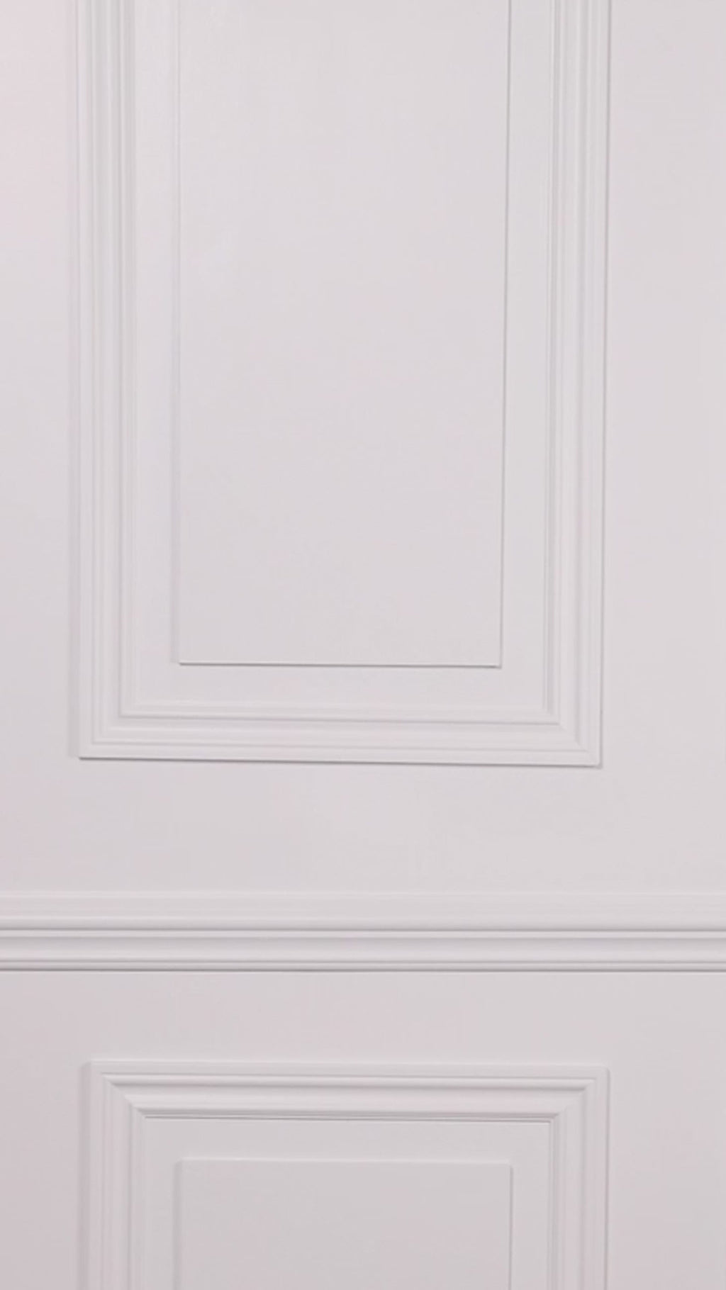 Video of a woman wearing a black swim romper one piece against a white background