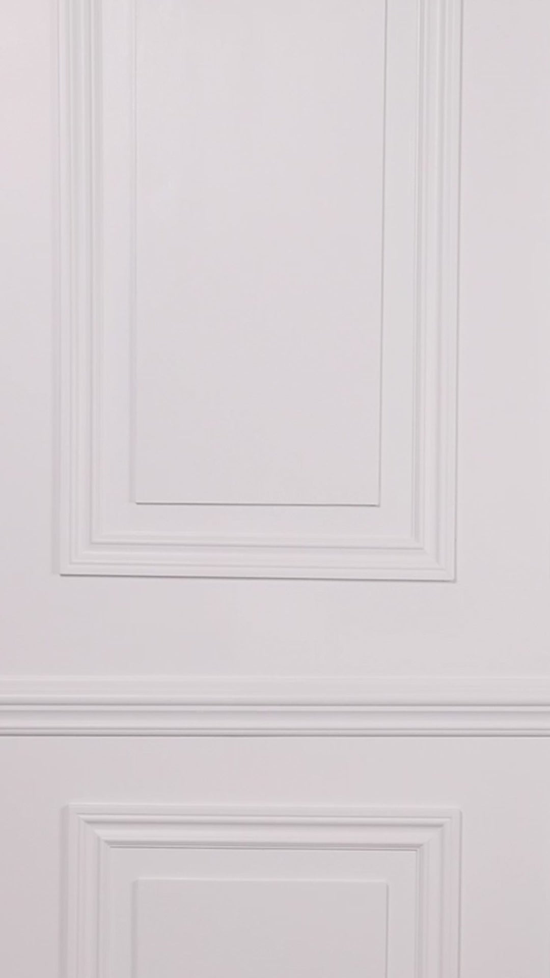 Video of a woman wearing a black swim romper one piece against a white background