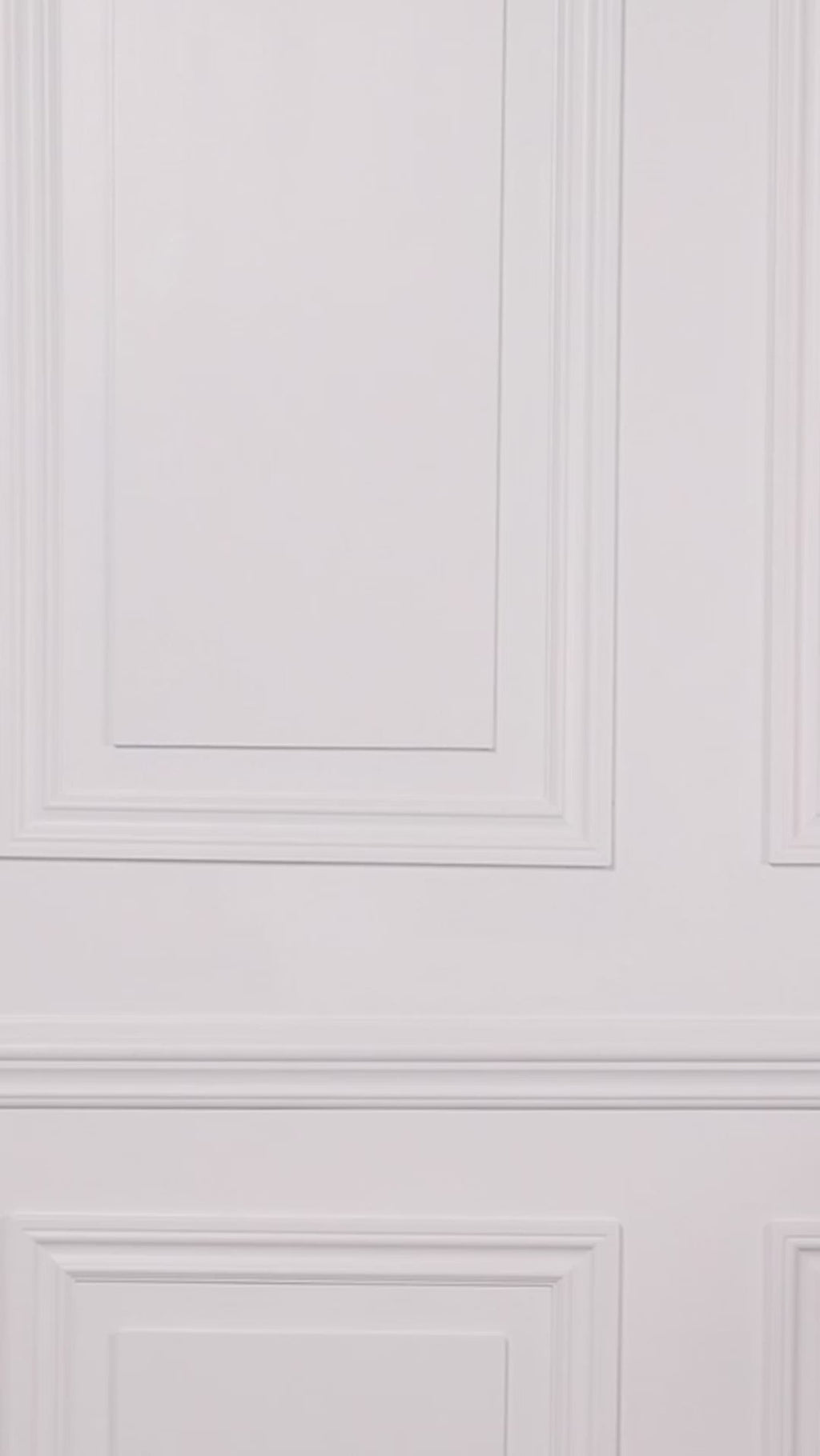 Video of a woman wearing a black and white patterned one-piece swimsuit on a white background