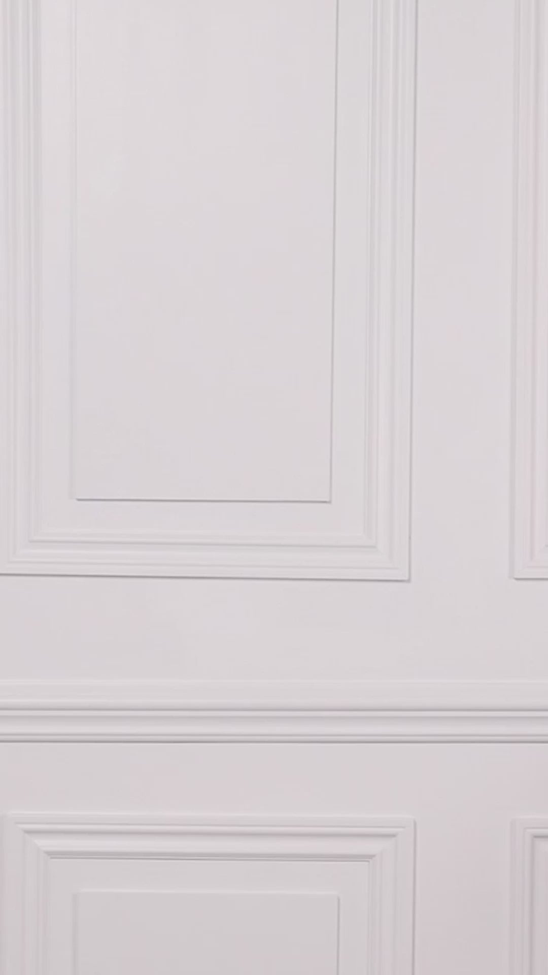 Video of a woman wearing a black and white patterned one-piece swimsuit on a white background